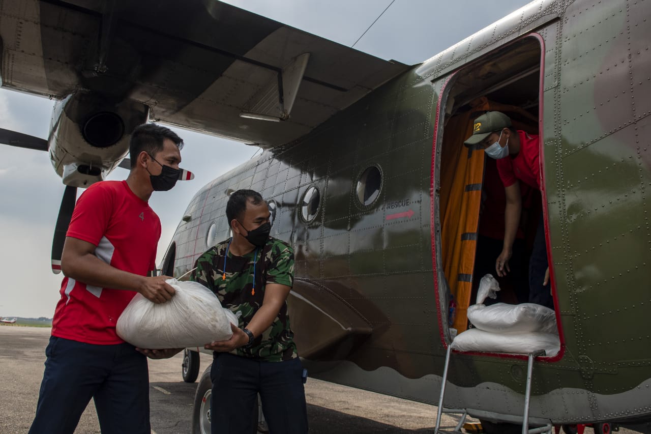 Prajurit TNI memindahkan garam ke pesawat Cassa C212 sebelum operasi TMC di Lanud Sri Mulyono Herlambang Palembang, Sumsel, Rabu (10/6).