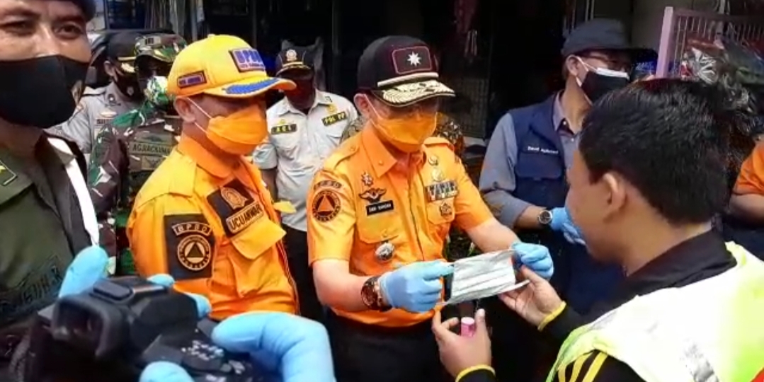 Kepala Pelaksana BPBD Jabar Dani Ramdan menyerahkan masker kepada warga