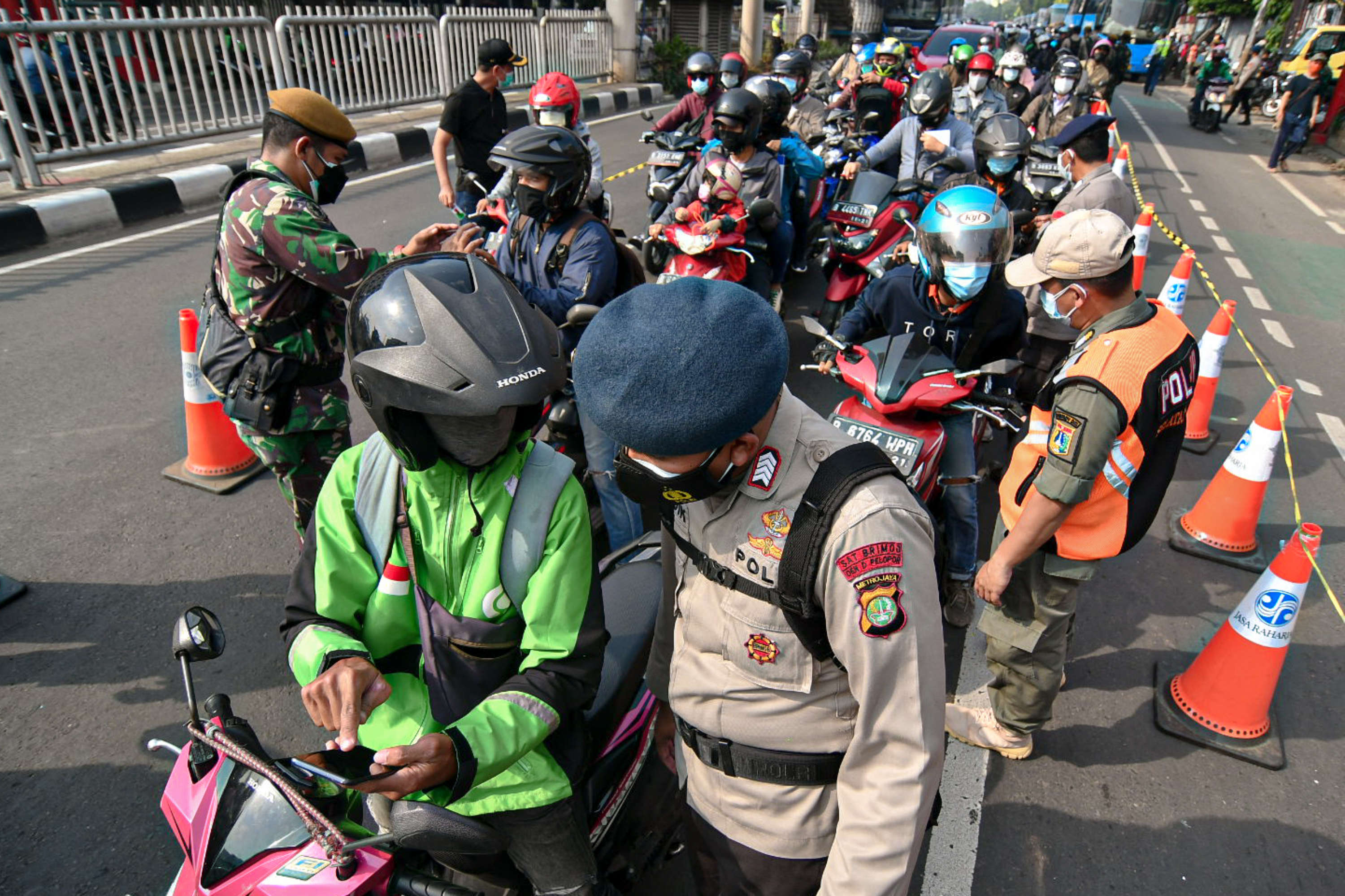 Petugas memeriksa kelengkapan Surat Tanda Registrasi Pekerja (STRP) di Jalan Mampang Prapatan Raya, Jakarta Selatan.