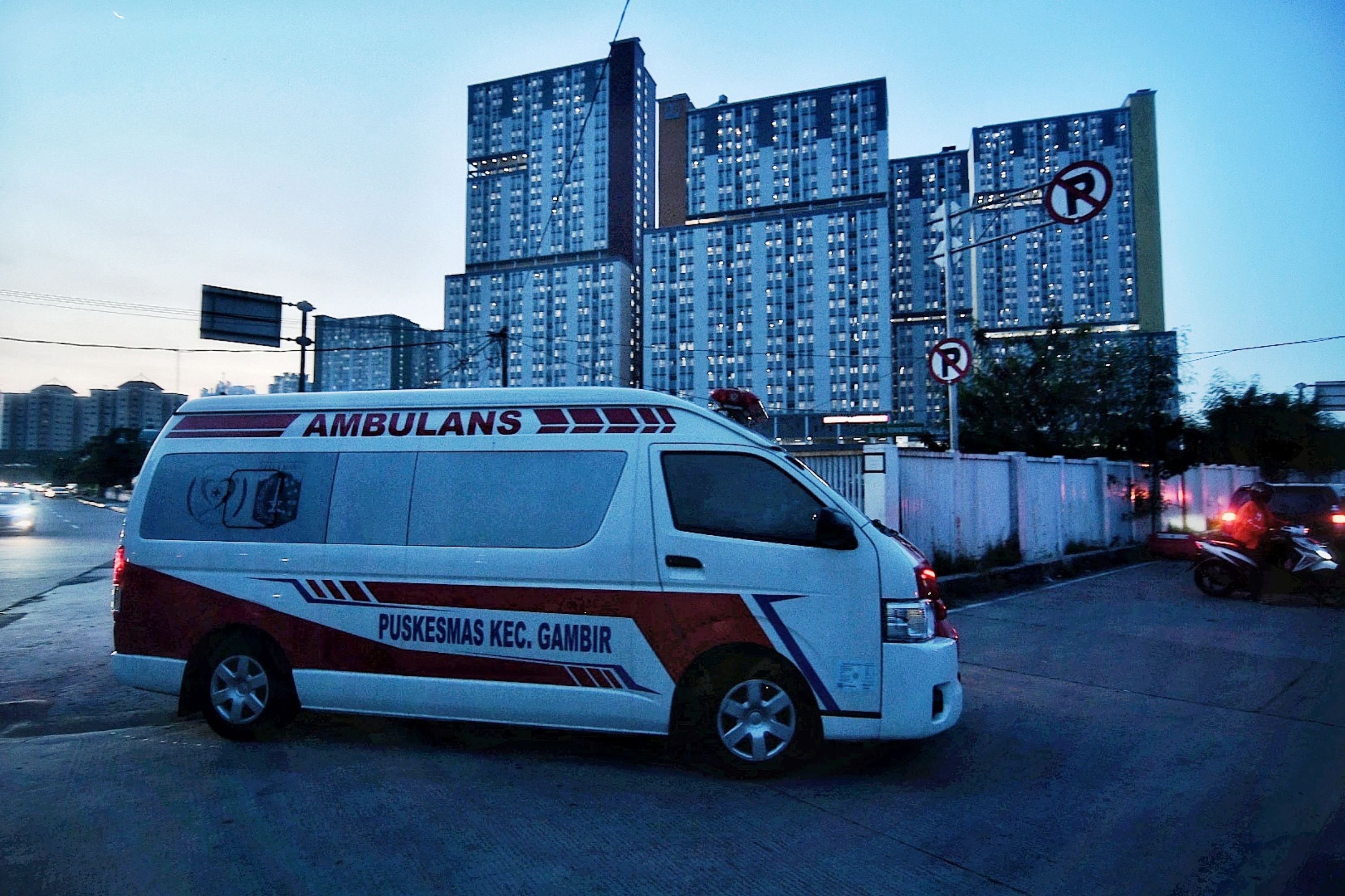 Kendaraan ambulance membawa pasien positif Covid-19 memasuki RSD Wisma Atlet Kemayoran, Minggu (13/6).