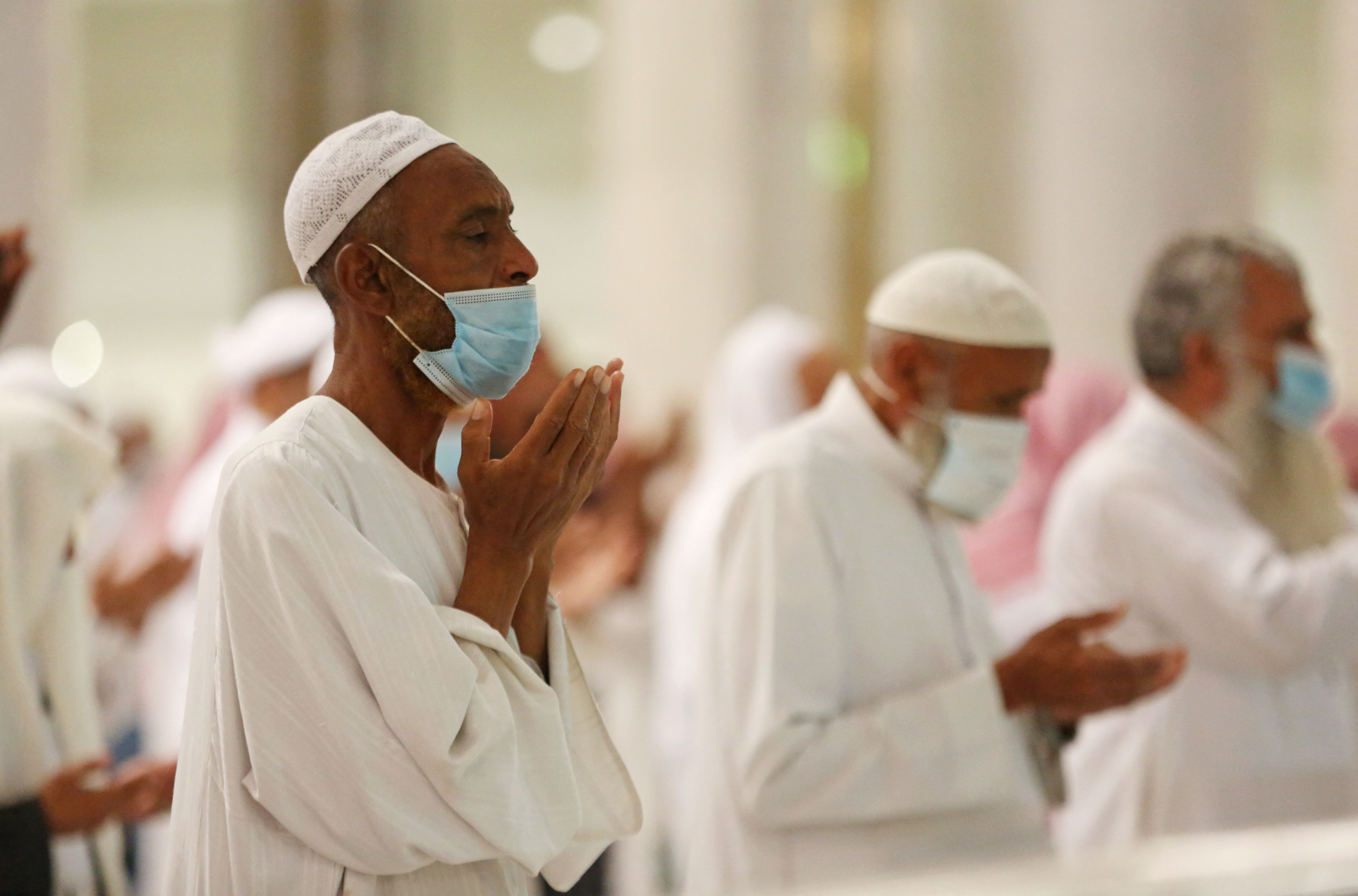 Umat muslim memakai masker berdoa di depan Kabah di Kota Suci Mekkah, Arab Saudi, April 2021. Arab Saudi berencana membuka umrah. 