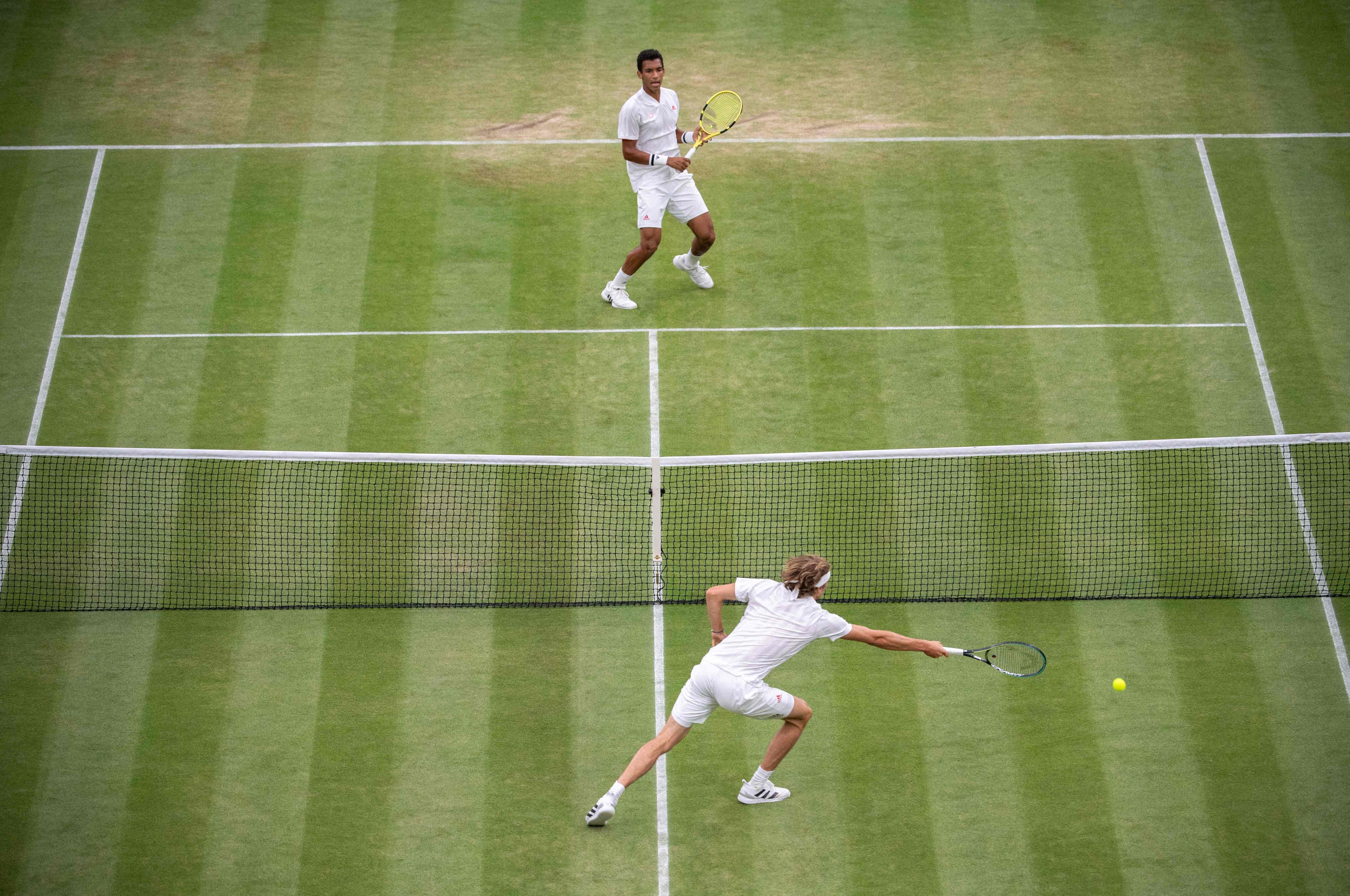 Pengembalian bola petenis Kanada Felix Auger-Aliassime (atas) tak dapat dijangkau petenis Jerman Alexander Zverev di laga babak keempat.