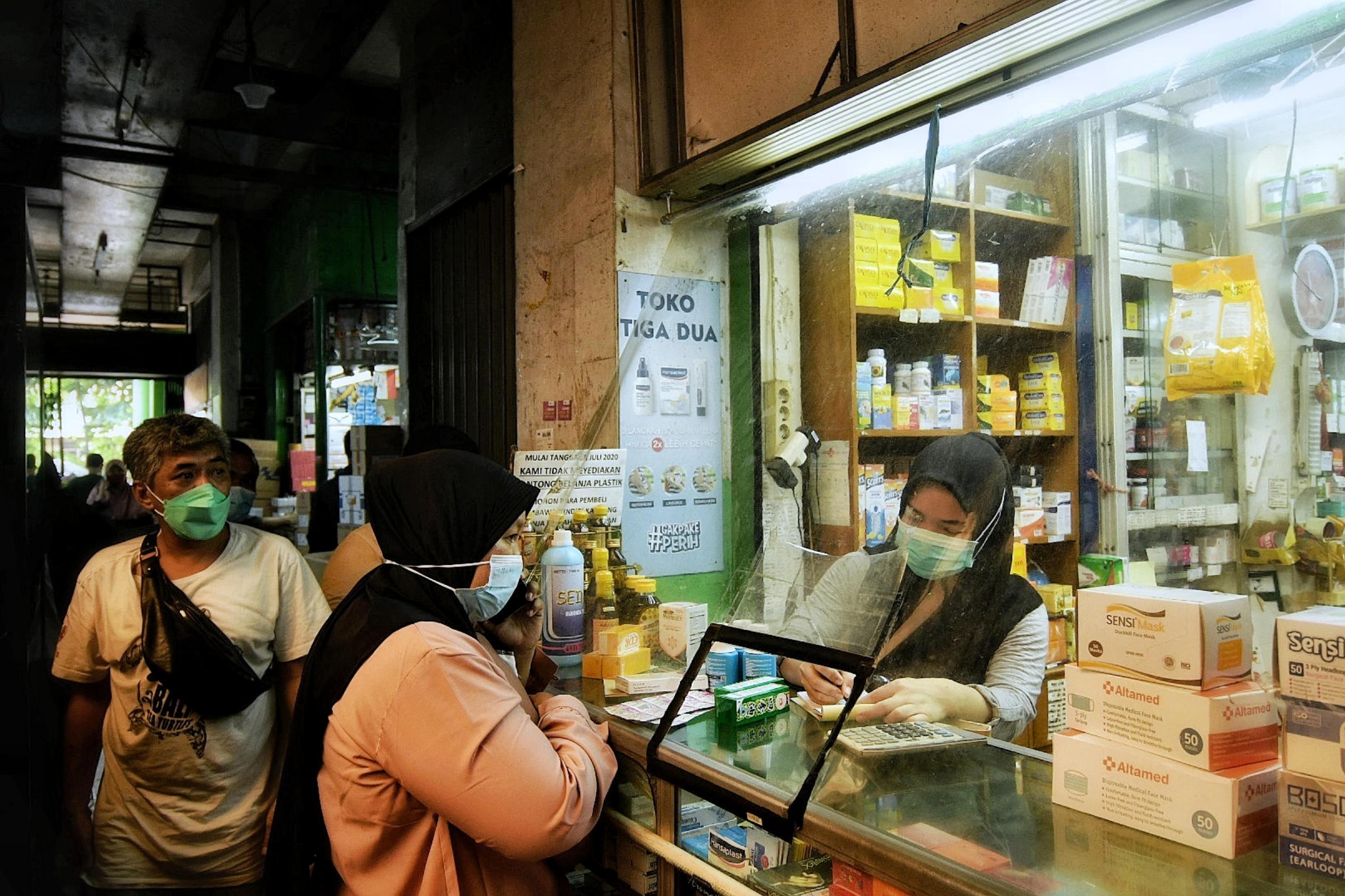 Warga saat membeli obat dan vitamin di Pasar Pramuka, Jakarta, Senin (28/6).