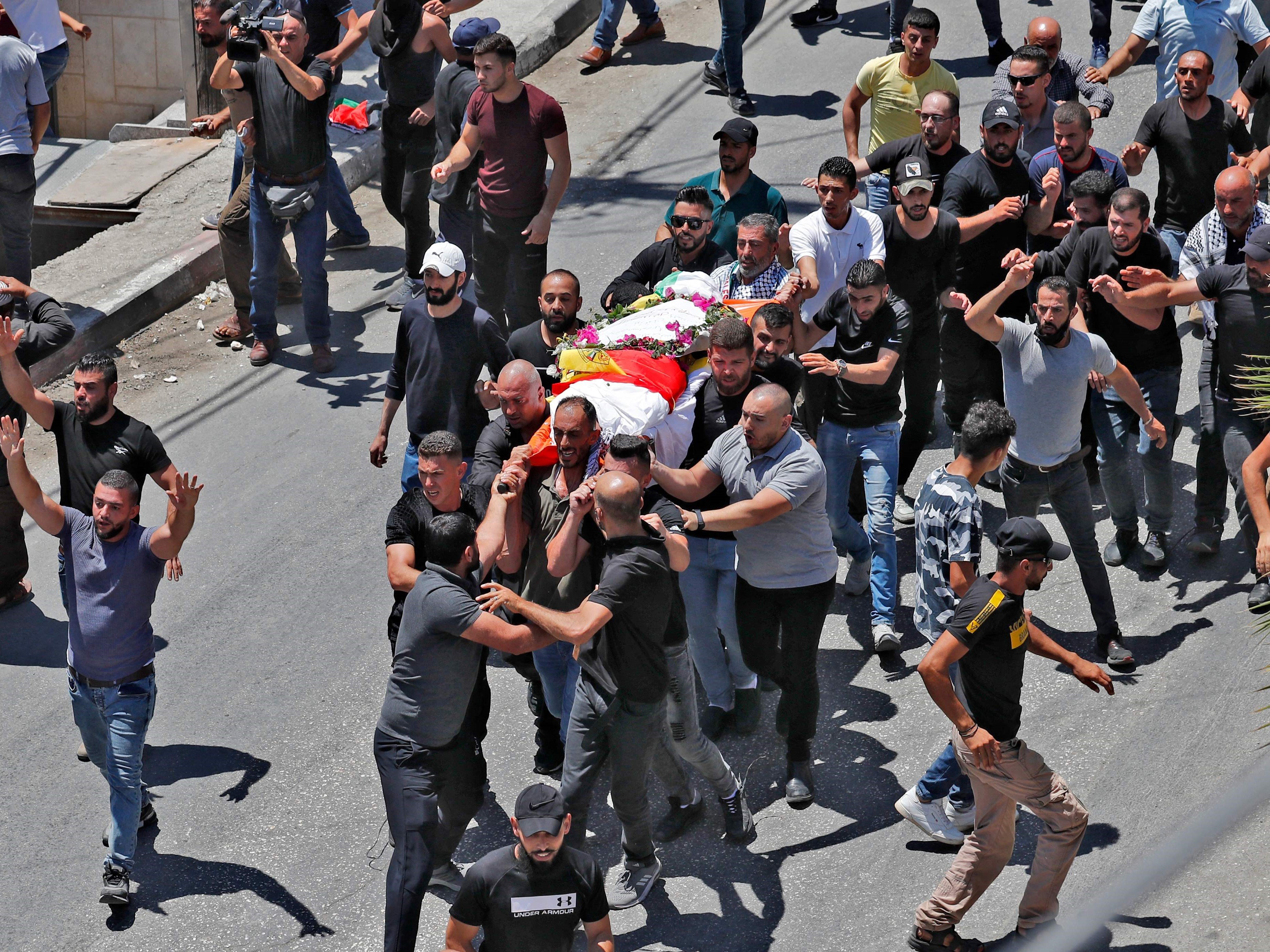 Para pelayat membawa jenazah Mohamad al-Alami, 12, selama pemakamannya di kota Beit Ummar, barat laut Hebron, Kamis (29/7).
