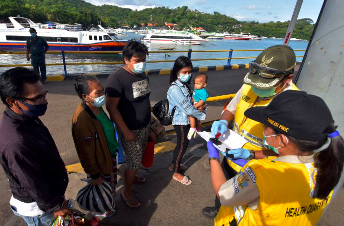 Petugas KKP Kelas I Denpasar memeriksa surat rapid test antigen milik warga yang baru tiba di Pelabuhan Padangbai, Karangasem, Bali.