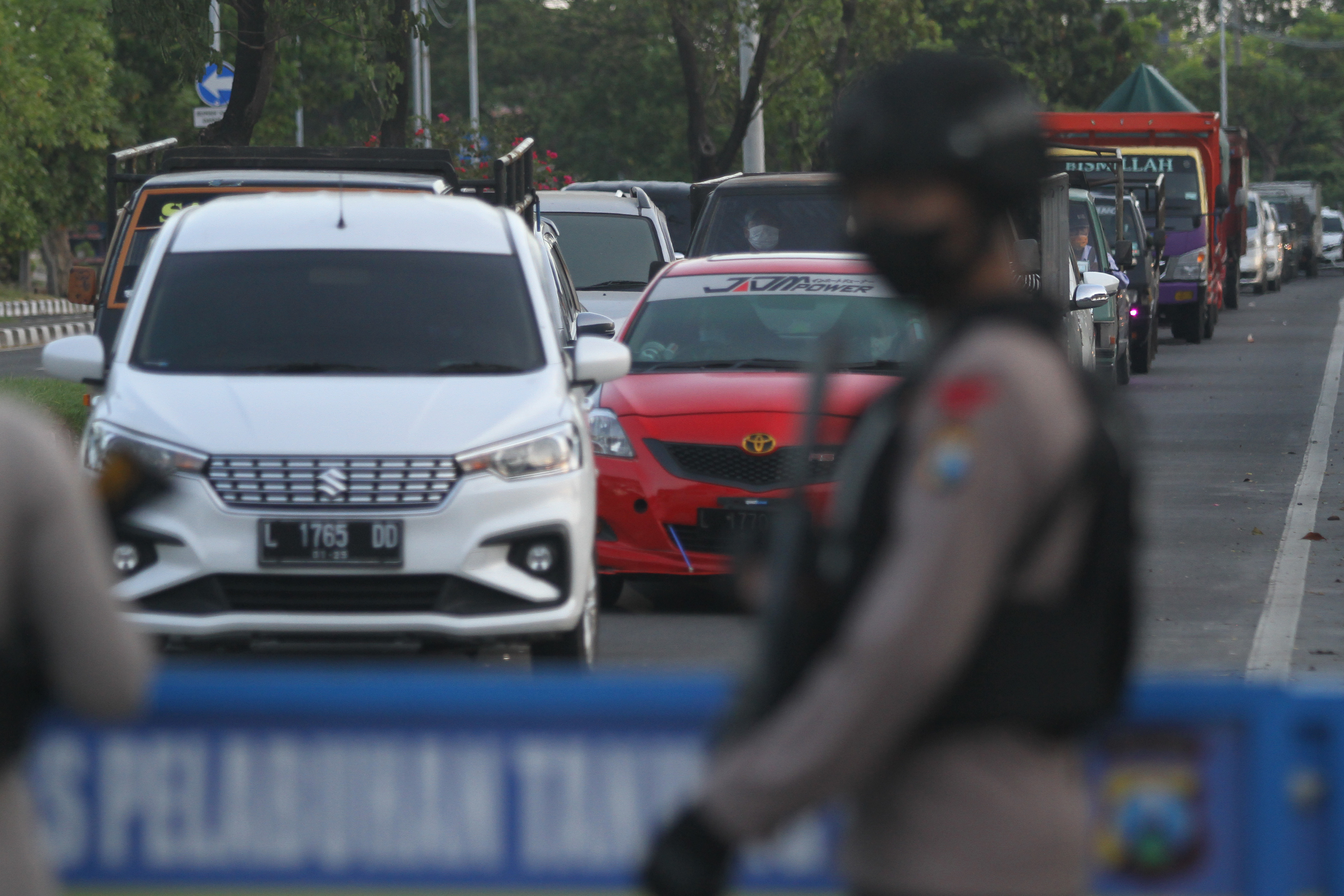 Petugas kepolisian berjaga di Pos penyekatan menuju Jembatan Suramadu di Surabaya, Jawa Timur, Senin (19/7/2021)
