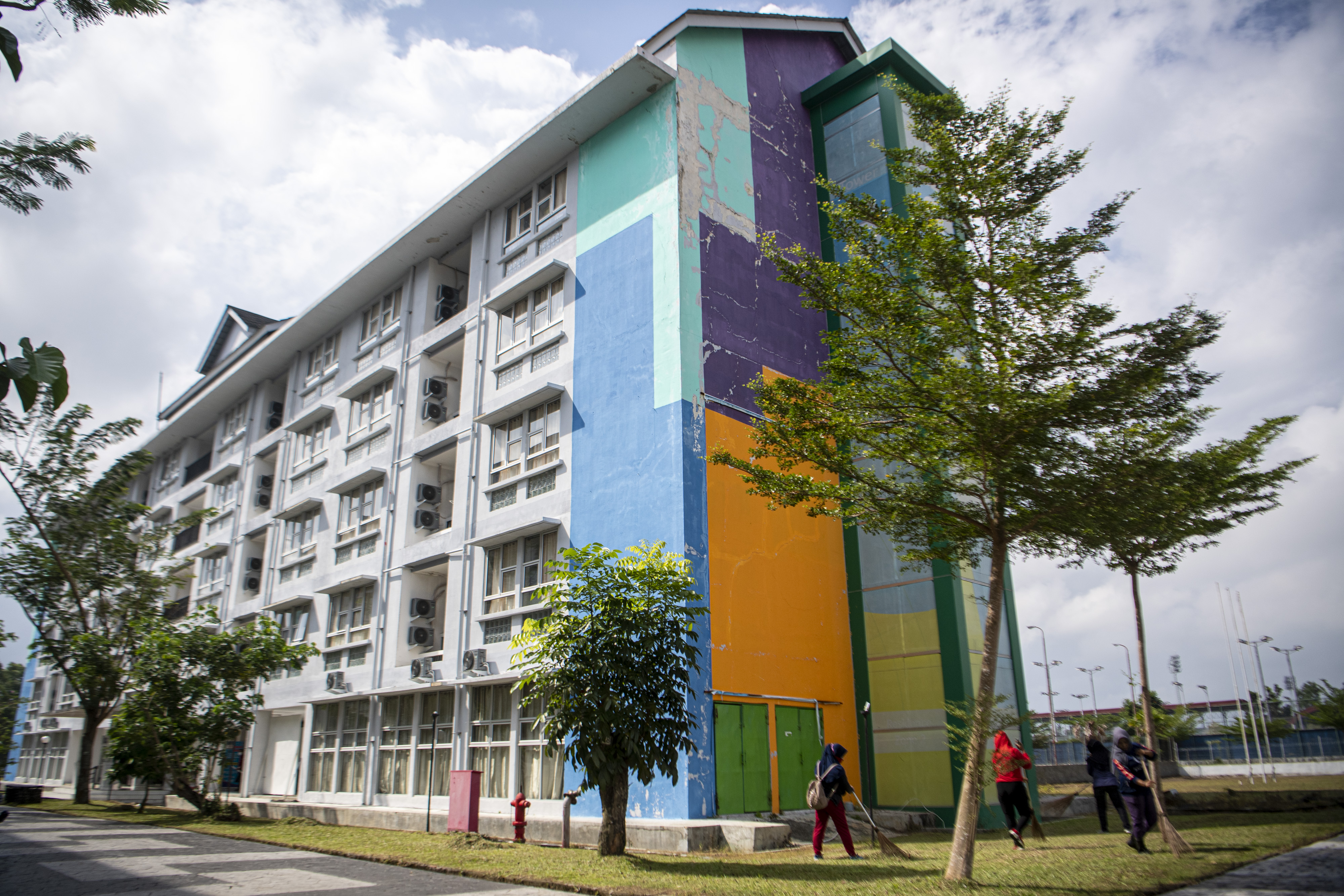 Petugas membersihkan halaman Wisma Atlet di Palembang, yang menjadi tempat perawatan pasien covid-19.