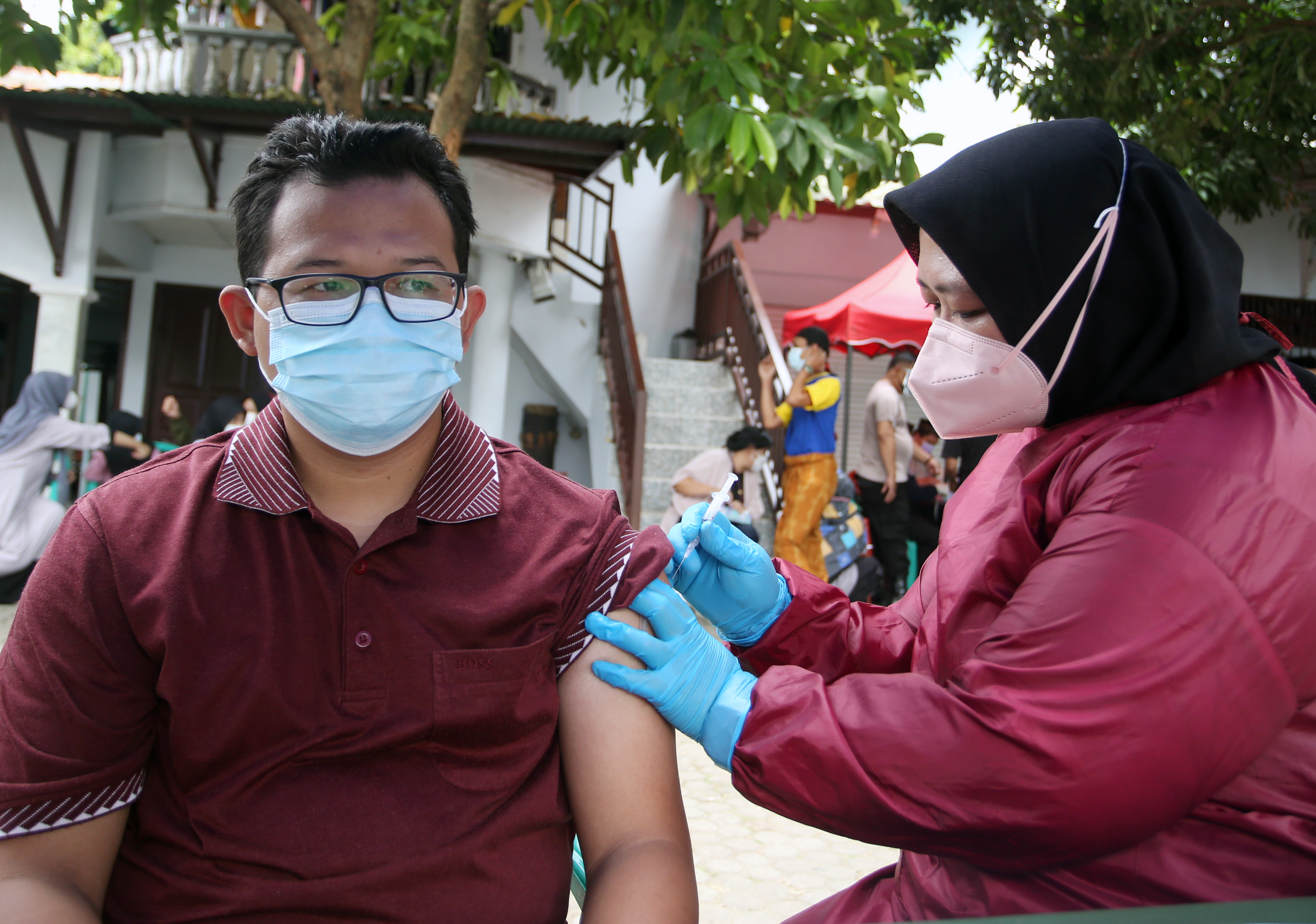 Petugas kesehatan menyuntikkan vaksin saat vaksinasi covid-19 dari rumah ke rumah di kawasan Pondok Cabe, Tangerang Selatan, Banten.