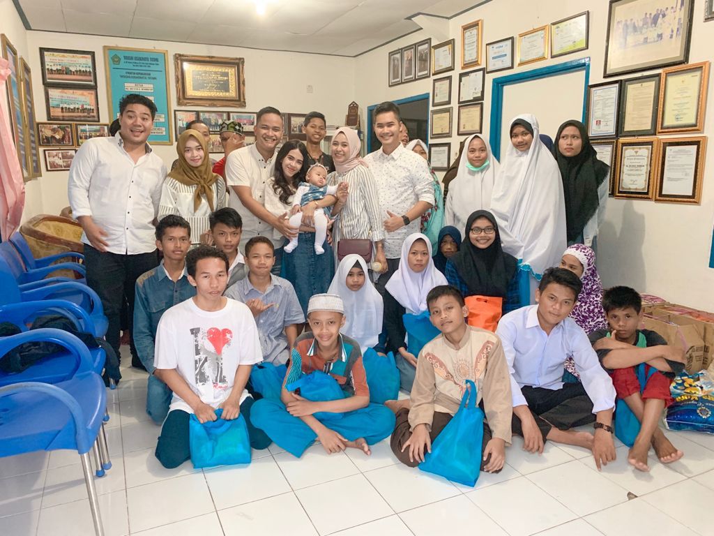 Nanda Adi Surya dan  Putri Rachmadania bersama sejumlah anak yatim piatu