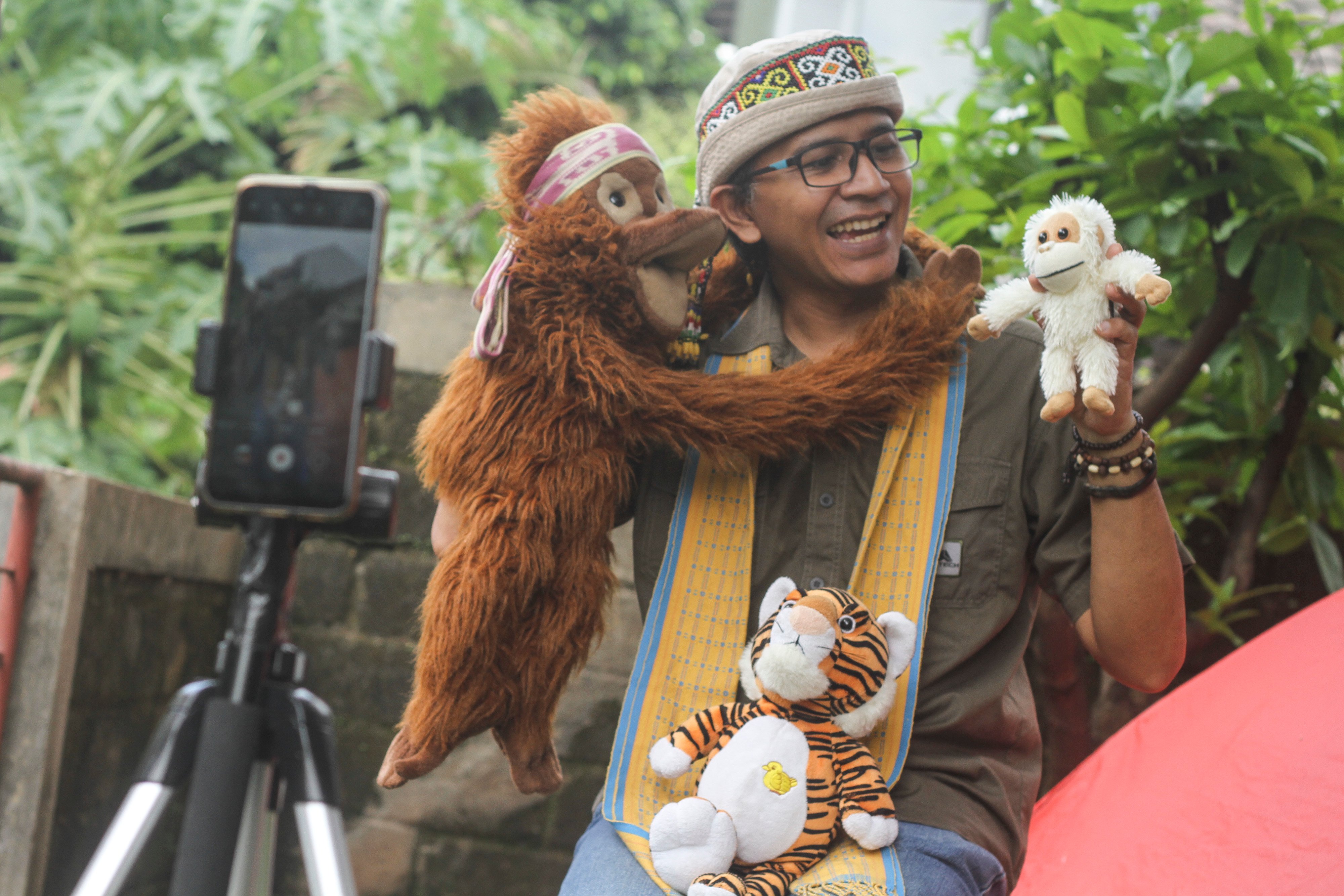 Pendongeng menggunakan boneka hewan sebagai media bercerita secara daring di Kelapa Dua, Depok, Jawa Barat,