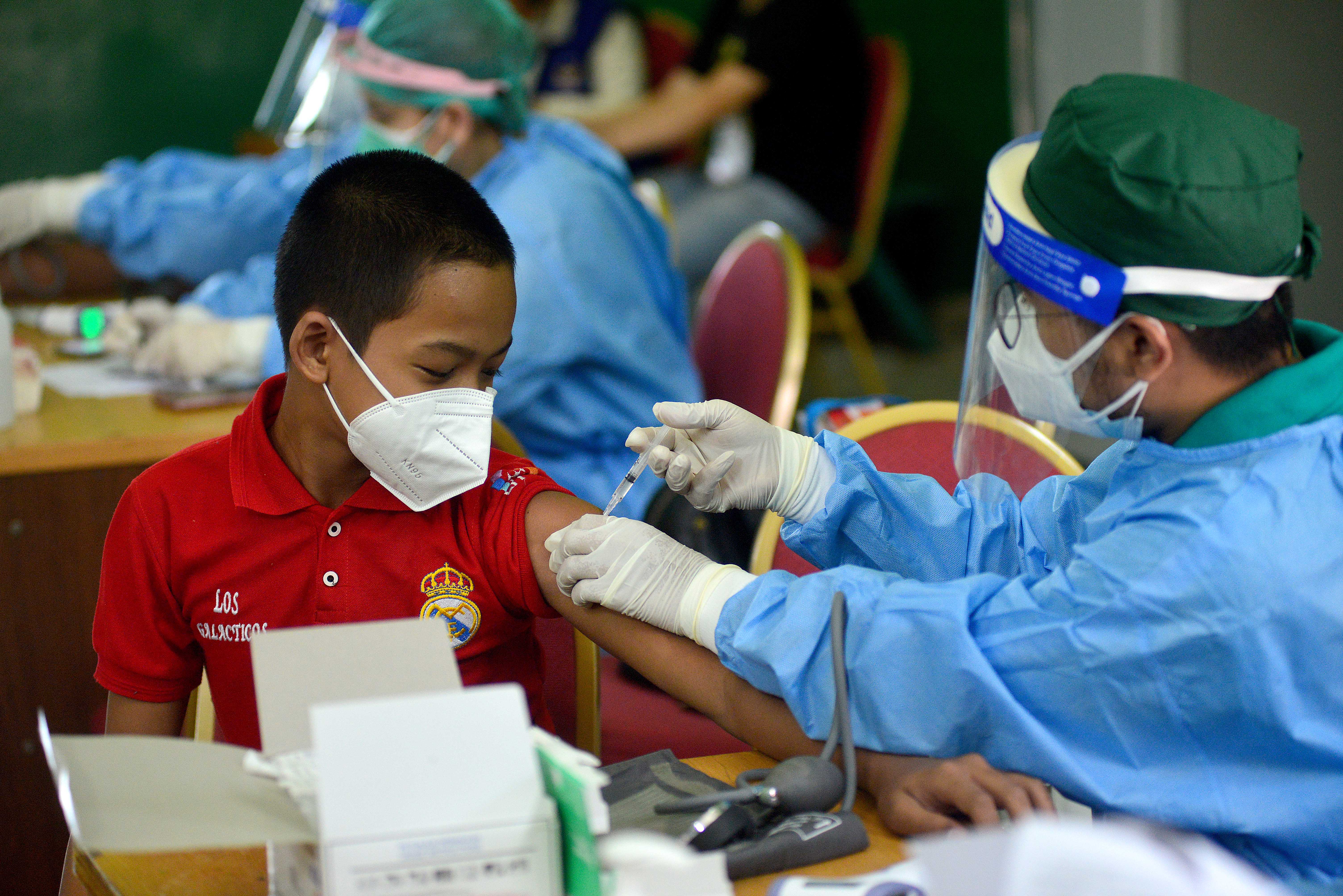 Tenaga kesehatan menyuntikkan vaksin covid-19 kepada anak di wilayah Jakarta.