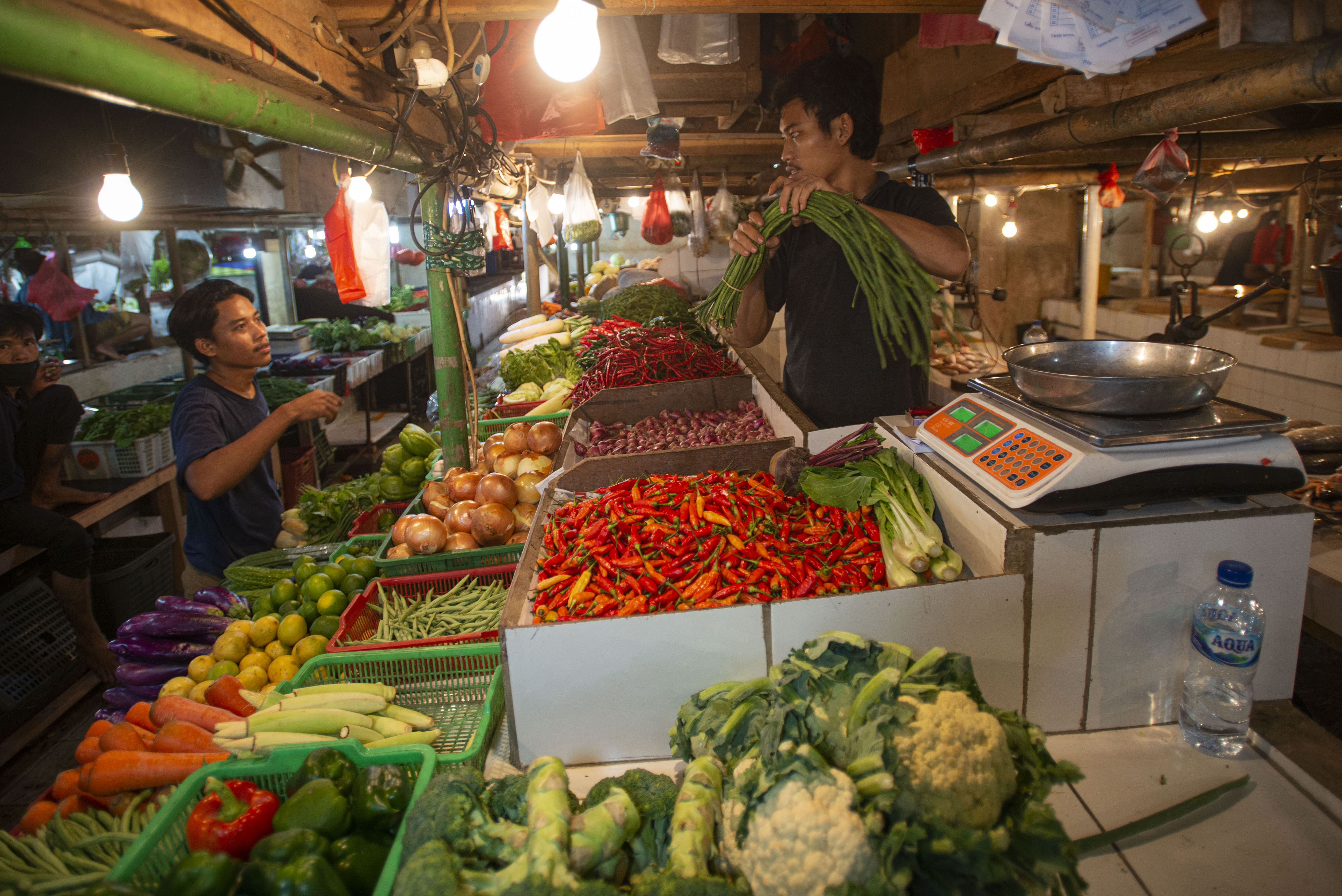 Pedagang melayani pembeli sayuran-sayuran di Pasar Senen, Jakarta, Senin (1/8).