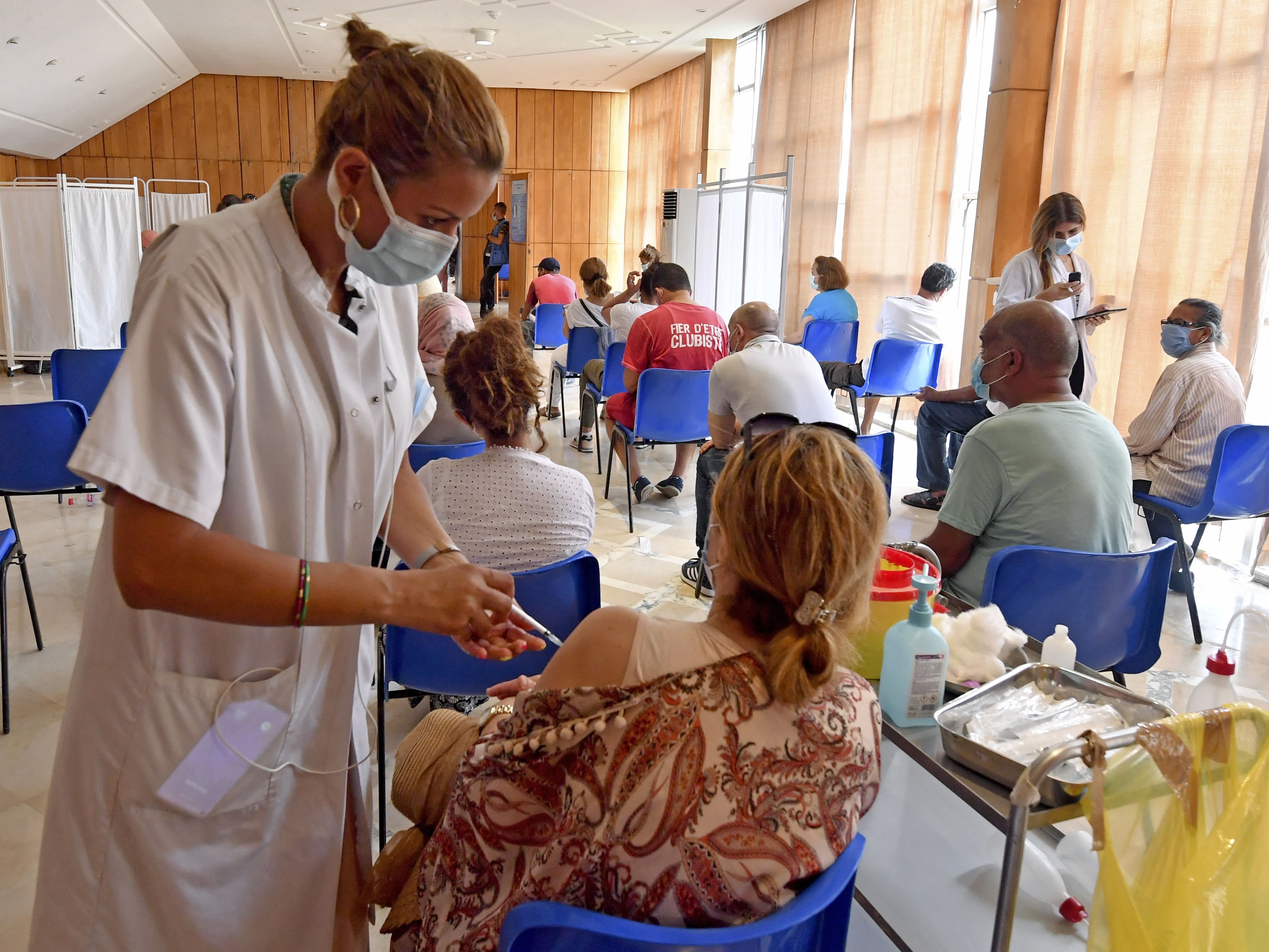 Seorang wanita Tunisia menerima dosis vaksin virus korona Johnson & Johnson di Stadion El-Menzah, Selasa (3/8).