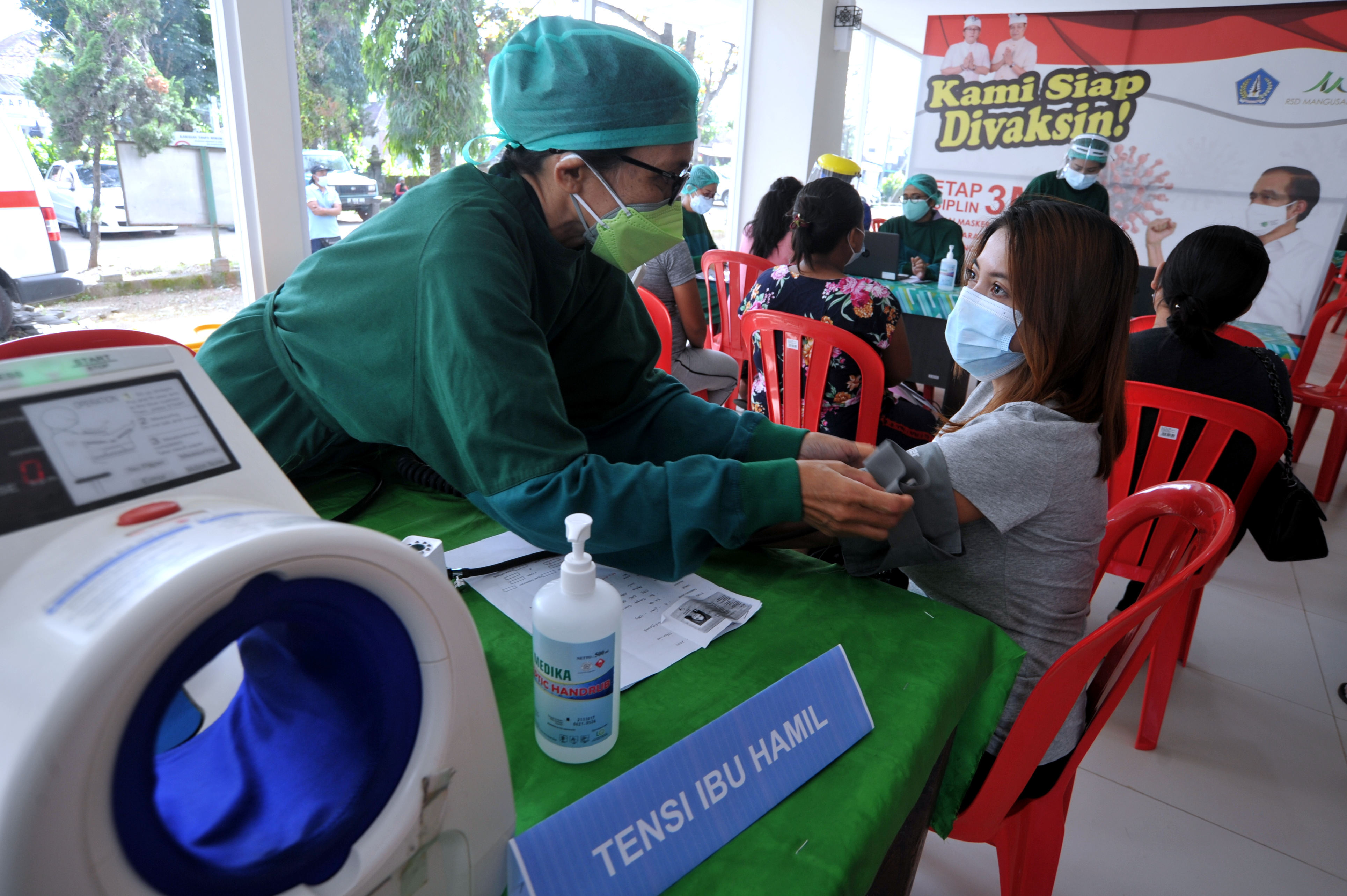Petugas melakukan pemeriksaan awal terhadap ibu hamil yang akan menerima vaksin covid-19 di RSD Mangusada, Badung, Bali, Kamis (19/8/2021)