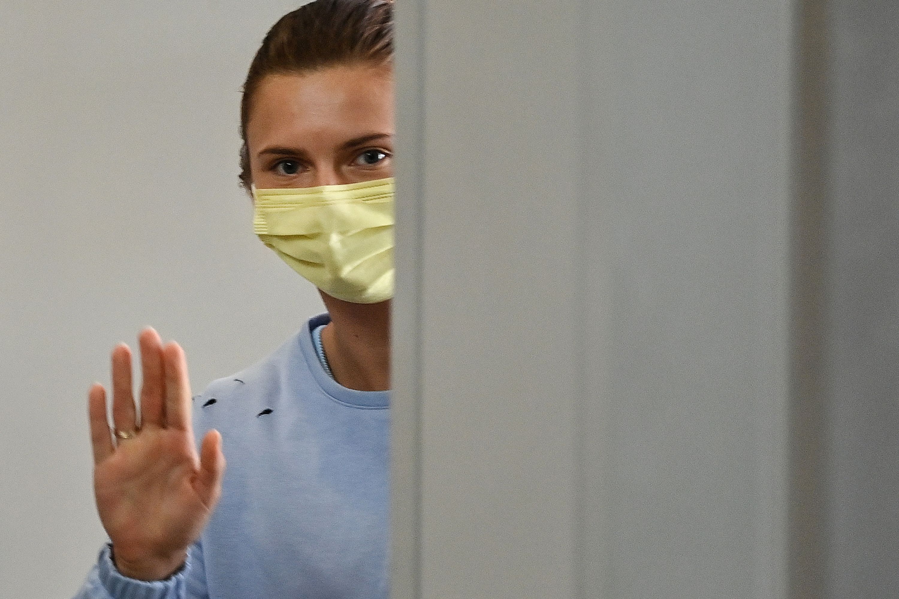 Atlet Belarus Krystsina Tsimanouskaya melambaikan tangan saat meninggalkan Bandara Haneda, Tokyo, Jepang.