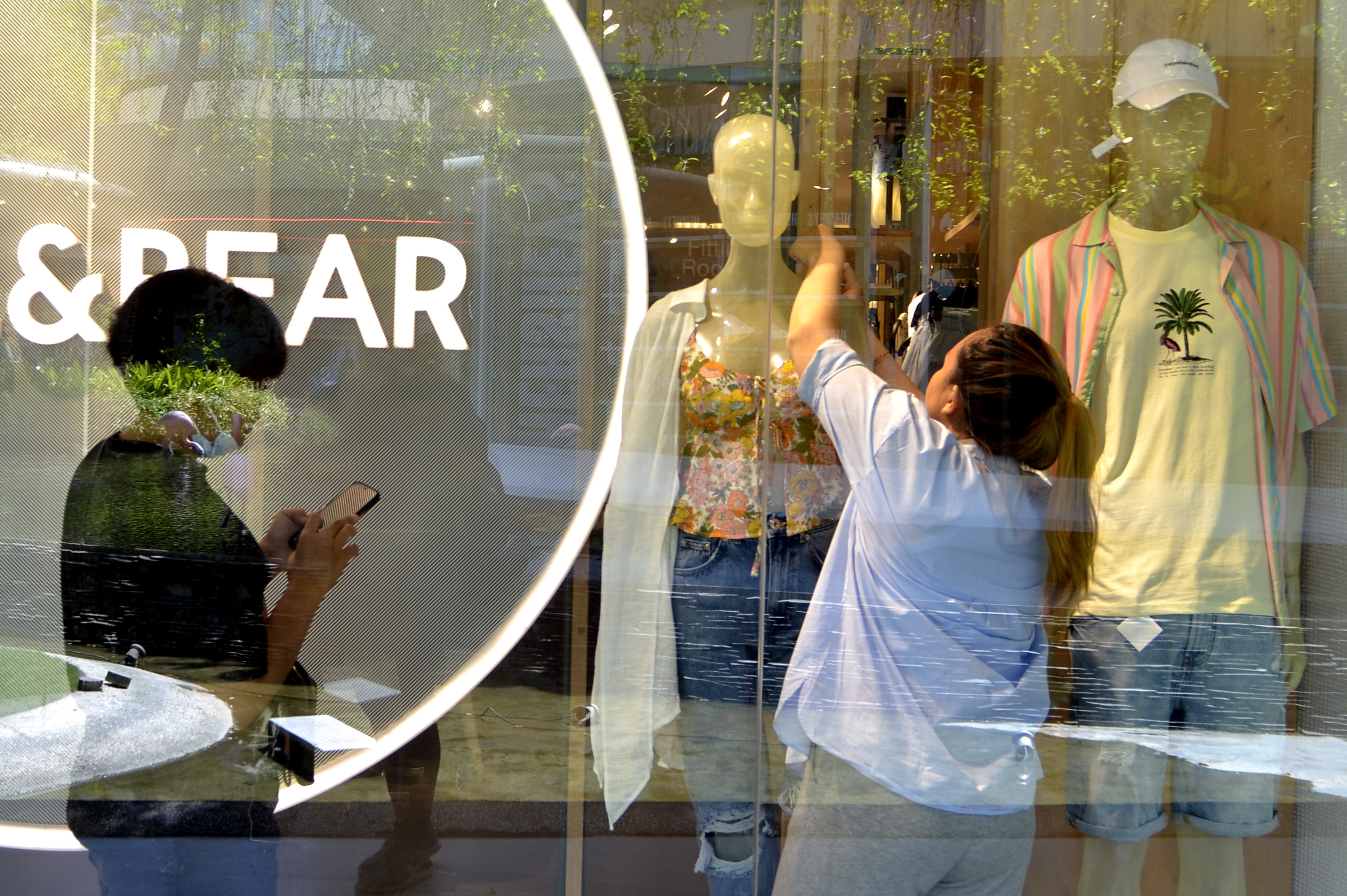 Pegawai tenant merapikan manekin saat hari pertama pembukaan mal di Beachwalk Shopping Center, Kuta, Badung, Bali, Rabu (8/9/2021).
