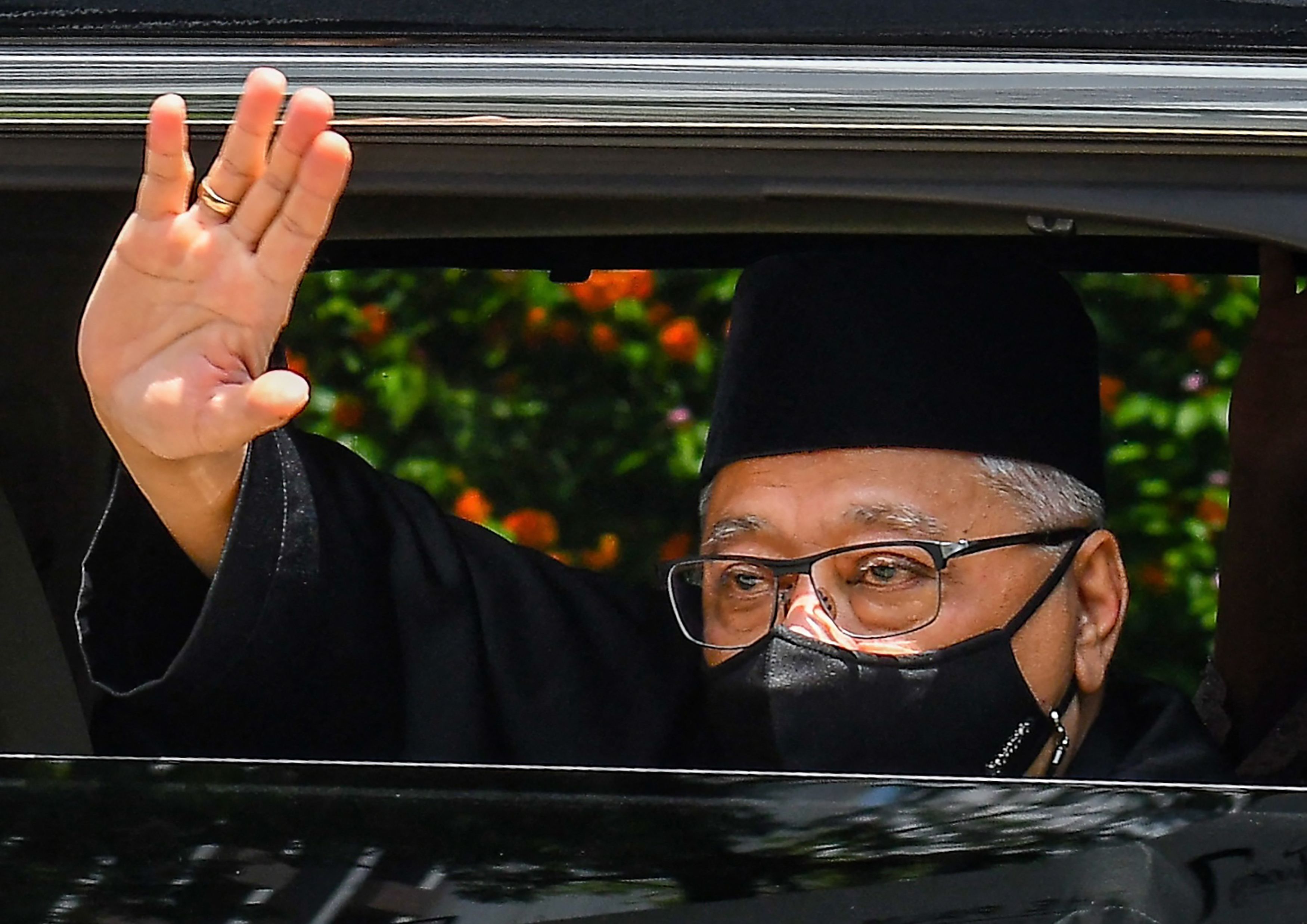 PM Malaysia Ismail Sabri Yaakob melambaikan tangan dari dalam mobilnya.