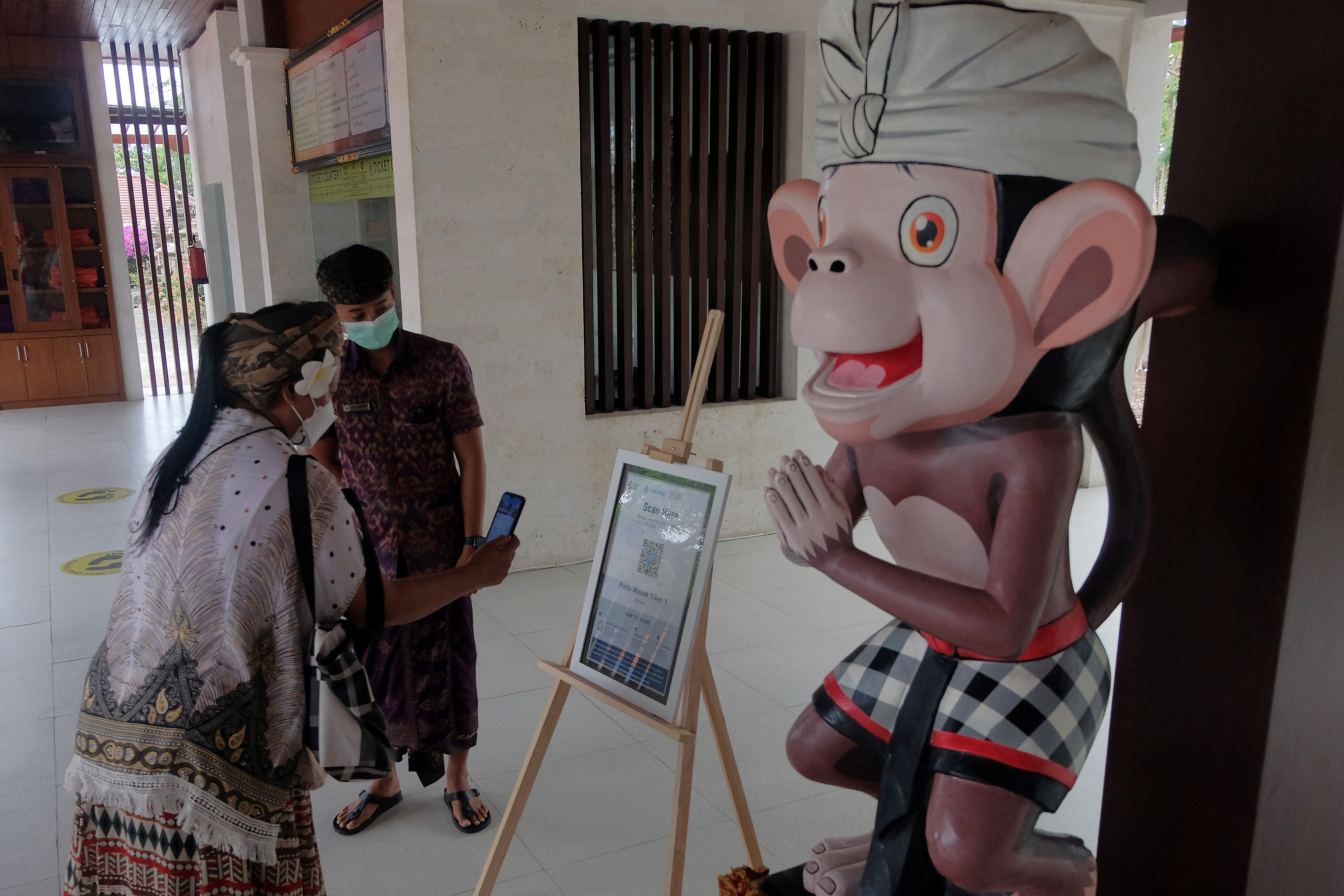 Wisatawan melakukan scan QR Code  melalui aplikasi PeduliLindungi di Daya Tarik Wisata (DTW) Uluwatu, Badung, Bali, Senin (13/9/2021). 