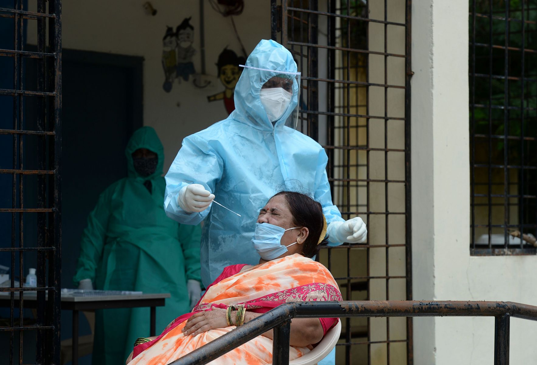 Petugas kesehatan melakukan tes cepat covid-19 terhadap warga di Hyderabad, India.  