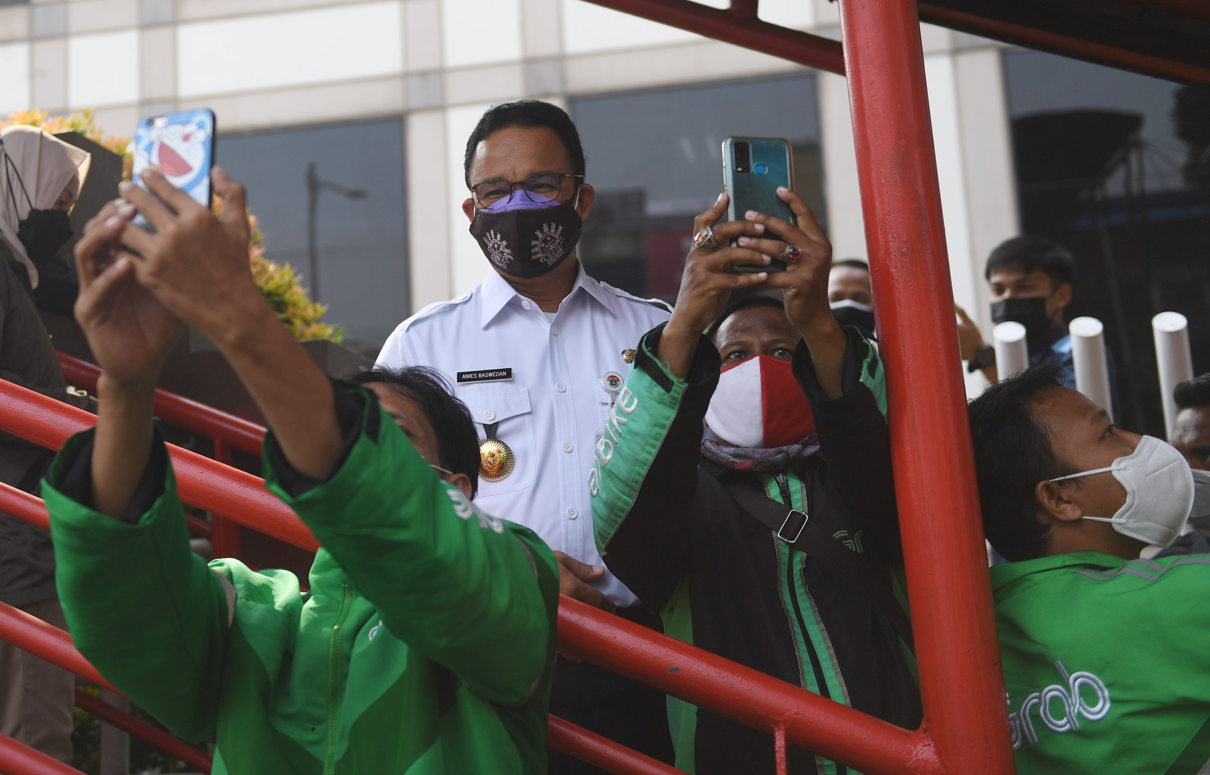Gubernur DKI Jakarta Anies Baswedan melayani permintaan swafoto pengemudi ojek daring