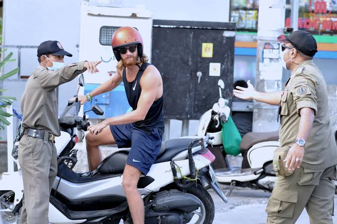 Petugas menghentikan pengendara tak bermasker