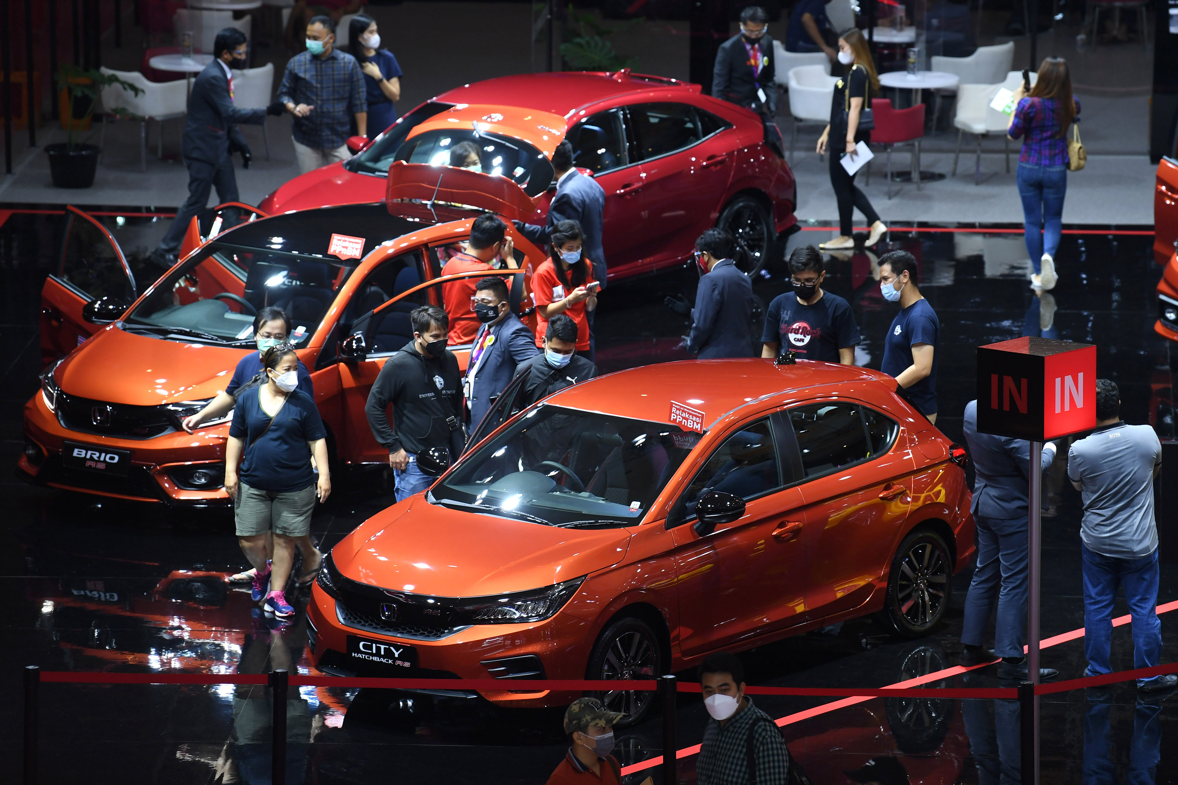 Sejumlah pengunjung mengamati mobil yang dipamerkan dalam IIMS Hybrid 2021 di JiExpo Kemayoran, Jakarta.