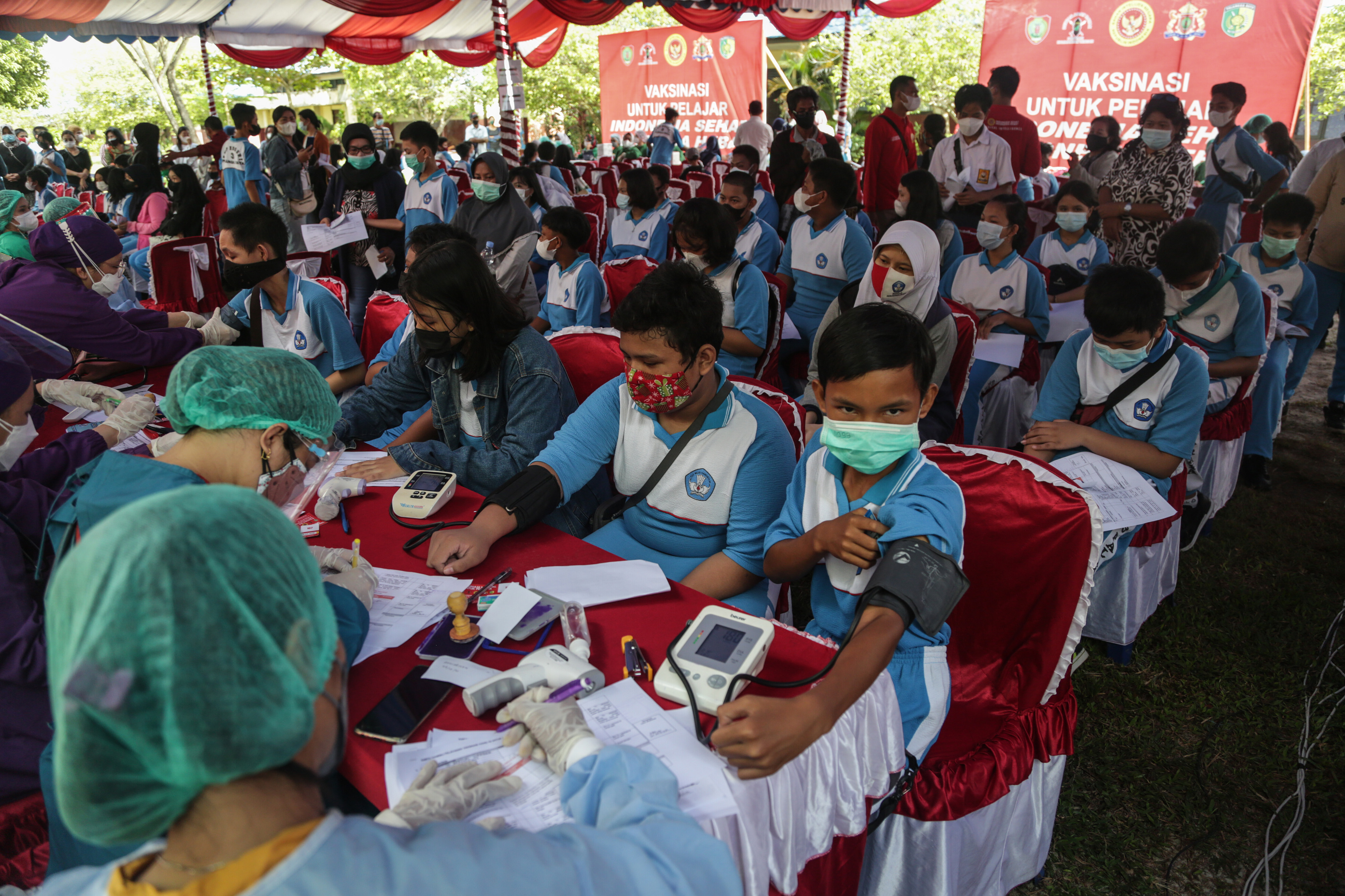 Petugas medis memeriksa kesehatan siswa sebelum disuntik vaksin covid-19 di SMPN 3 Palangkaraya, Kalimantan Tengah, Selasa (28/9/2021).