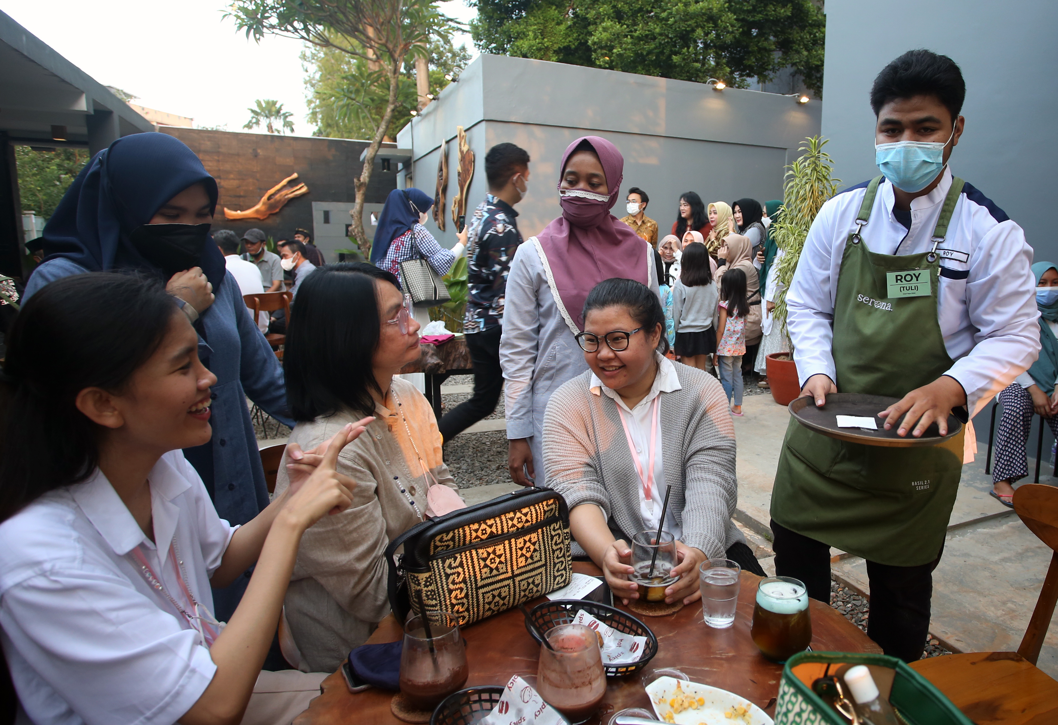 Pelayan kafe penyandang tuna rungu melayani pengunjung di Kafe Taman Tuli Serona Bintaro, Tangerang, Selatan, Banten, Jumat (24/9/2021).