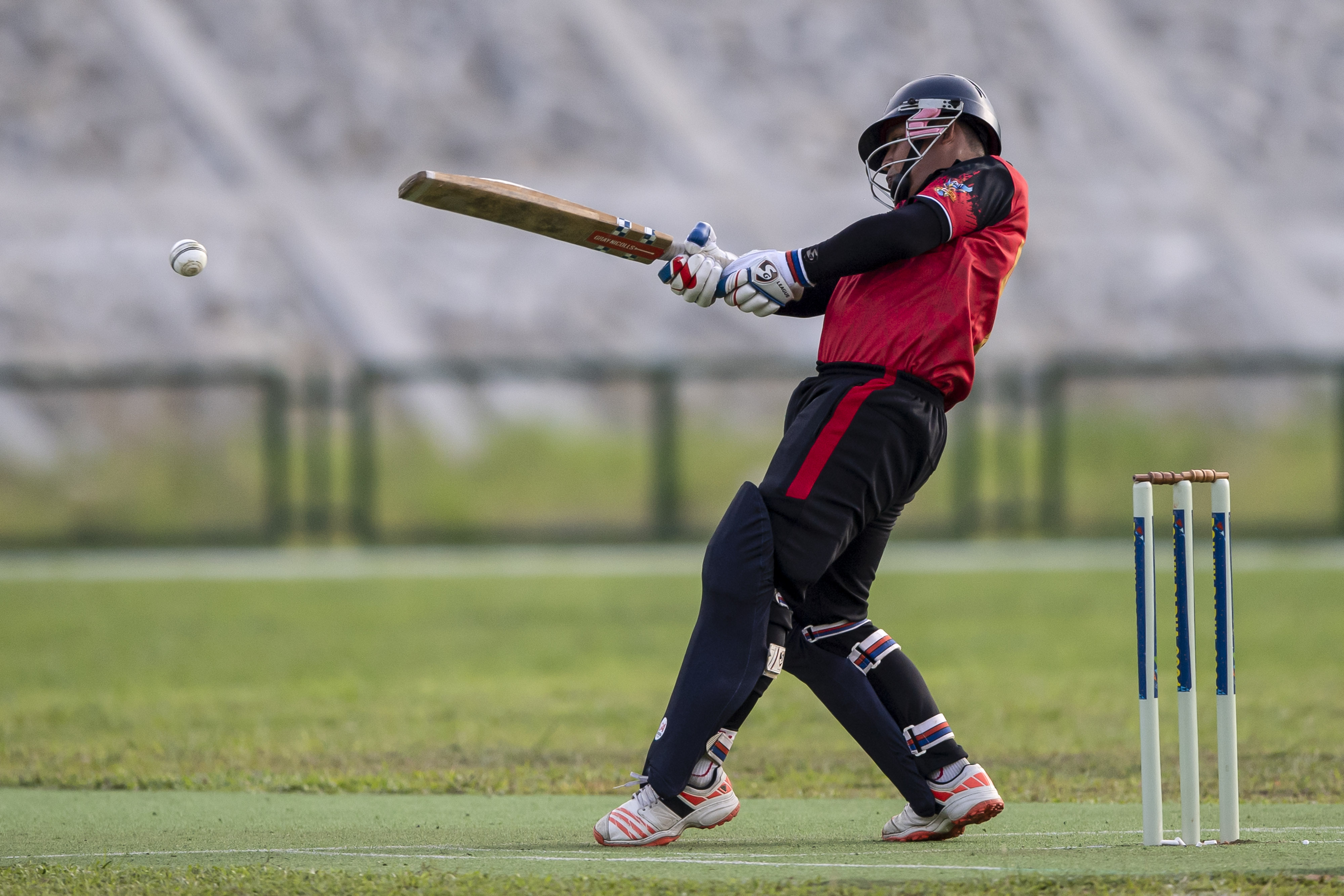 Pemain kriket putra DKI Muhaddis memukul bola dalam penyisihan grup A PON Papua.