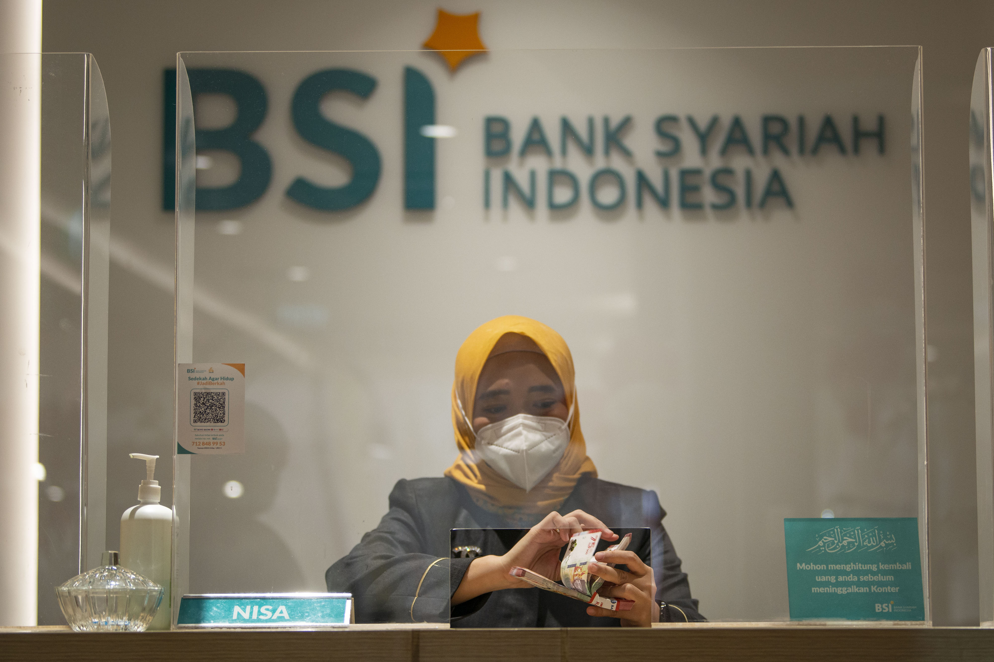 Karyawan menghitung uang di Kantor Cabang Digital Bank Syariah Indonesia wilayah Jakarta.