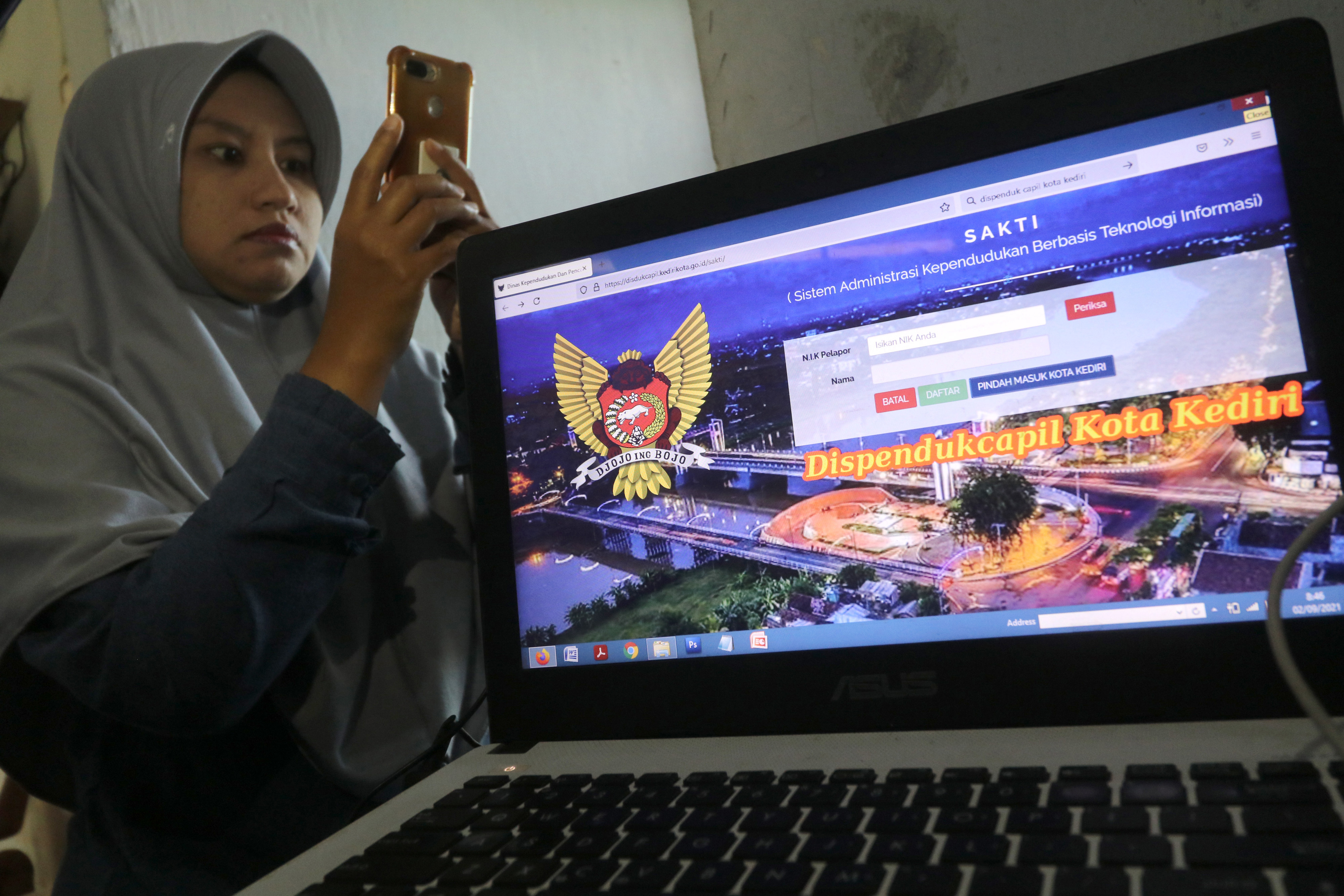 Warga mencoba aplikasi Sistem Administrasi Kependudukan Berbasis Teknologi Informasi (Sakti) melalui gawainya di Kota Kediri.