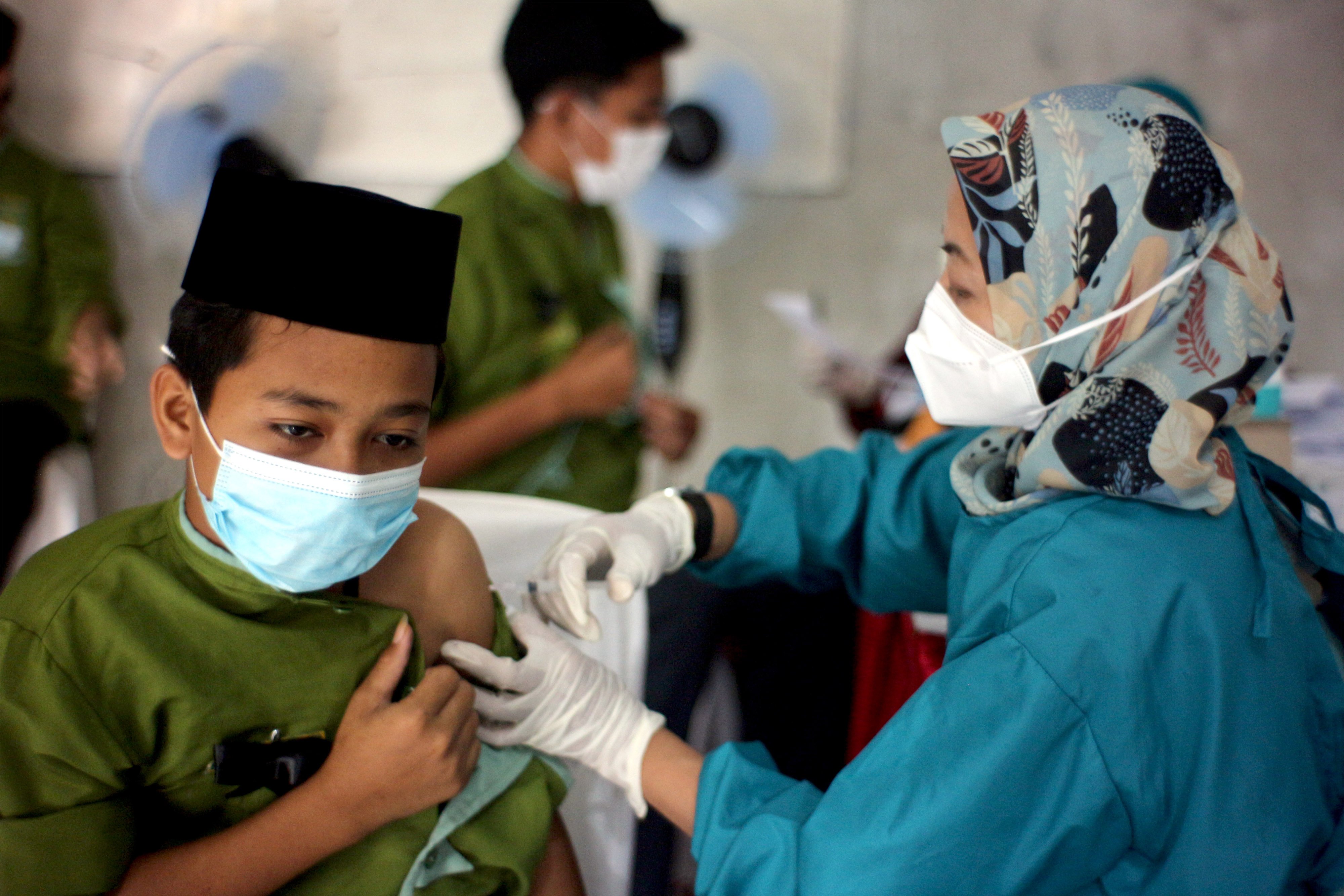 Petugas medis menyuntikan vaksin covid-19 kepada santri di Pondok Pesantren Daarur Rasul, Kabupaten Bogor, Jawa Barat, Jumat (19/11/2021)