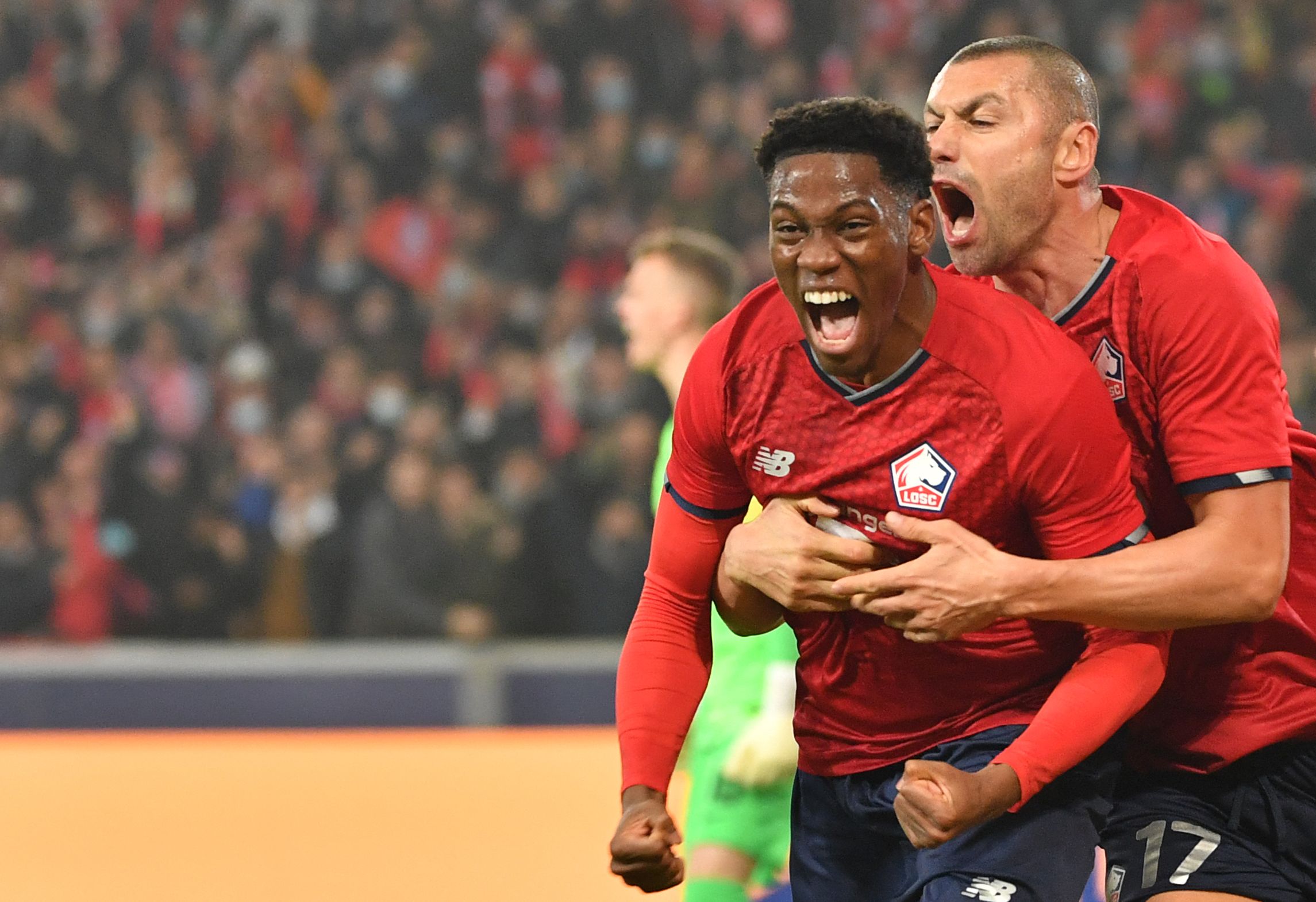Penyerang Lille Jonathan David melakukan selebrasi usai mencetak gol ke gawang Salzburg di laga Liga Champions.