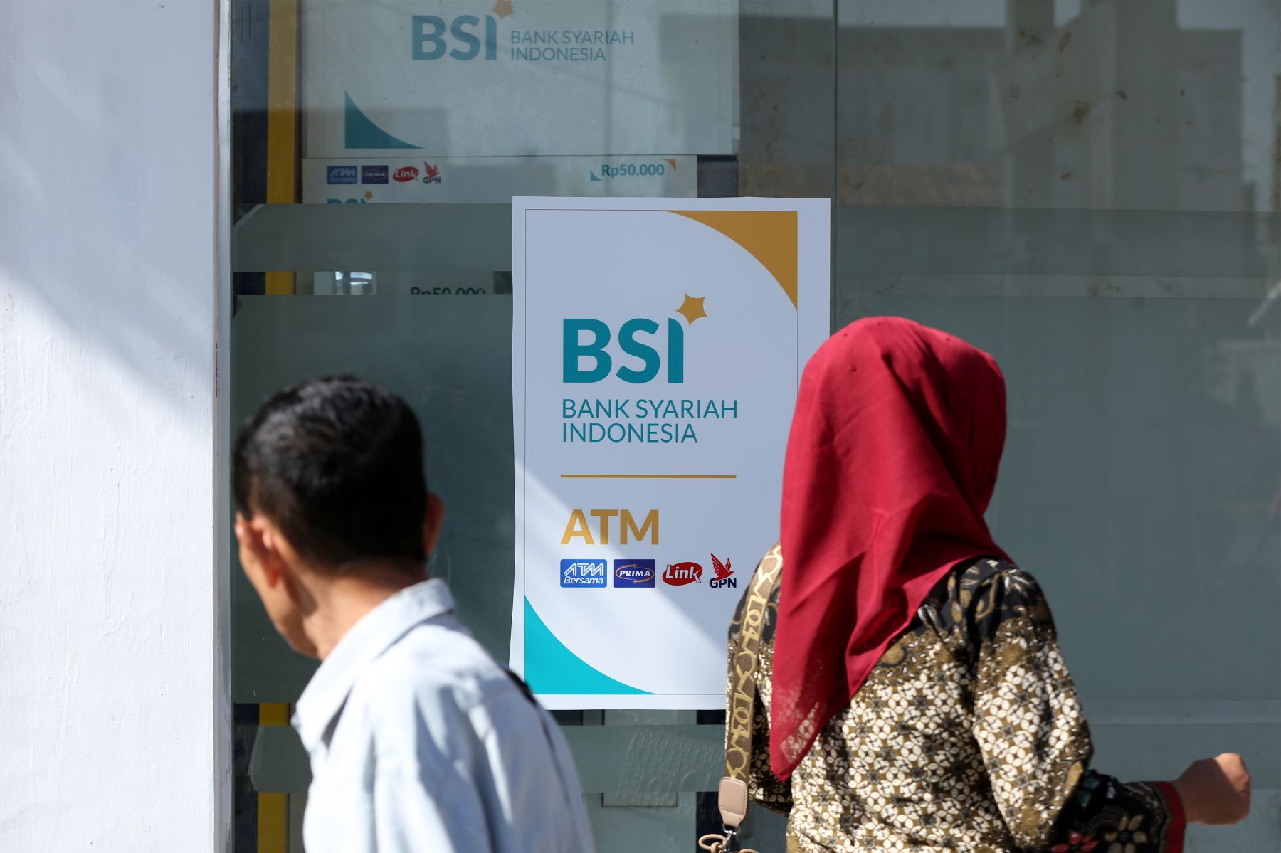 Ilustrasi warga antre untuk mengambil uang di ATM Bank Syariah Indonesia. 