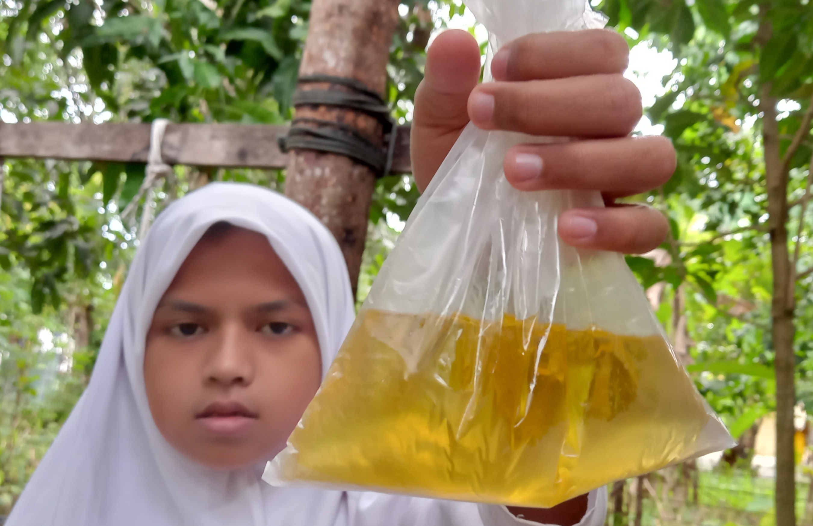 Warga menunjukkan minyak goreng curah yang harganya di Provinsi Aceh naik sejak dua bulan terakhir, Senin (8/11)