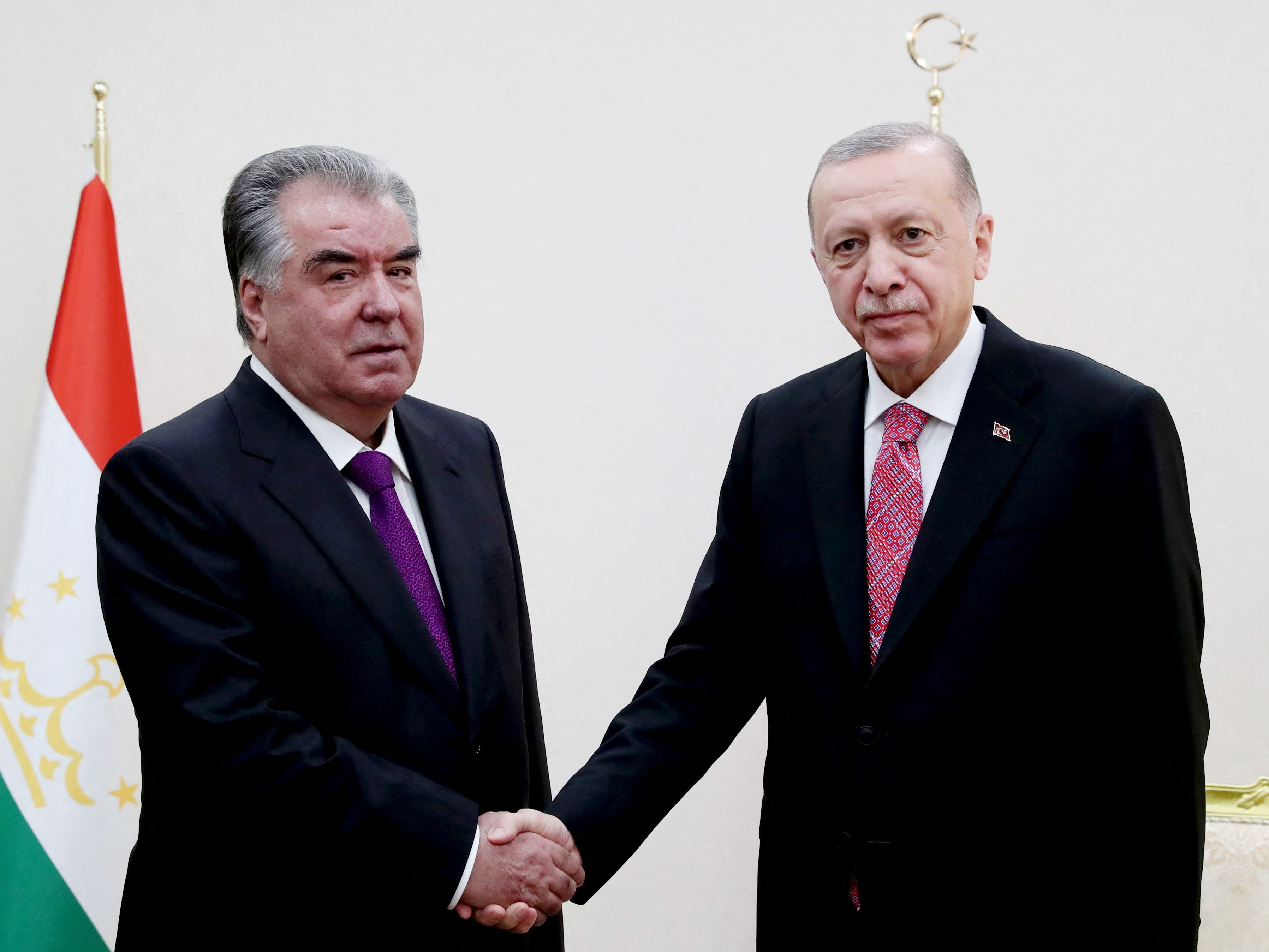 Presiden Turki Recep Tayyip Erdogan (kanan) berjabat tangan dengan Presiden Tajikistan Emomali Rahmon (kiri).