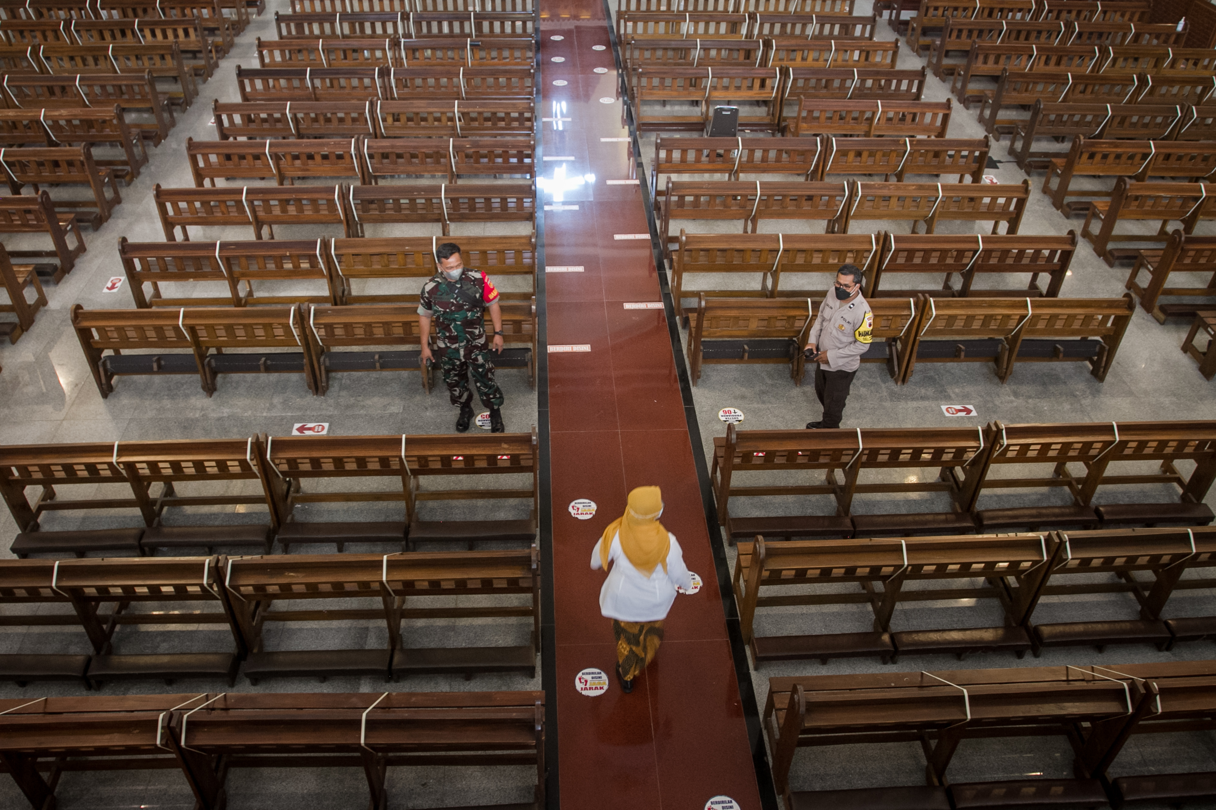 Anggota TNI dan Polisi memeriksa pembatas kursi jamaat saat pengecekan penerapan prokes bersama Forkopimda, di Gereja Katolik Santo Paulus, 