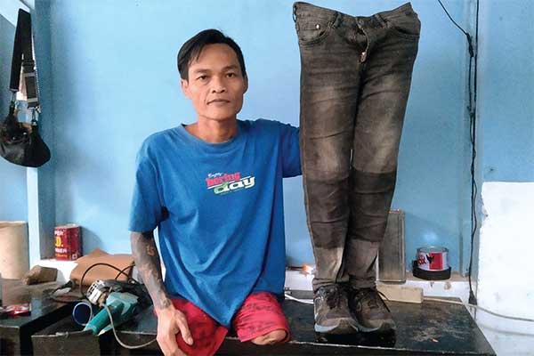 Indra Sumedi, 48, penyandang disabilitas tunadaksa, memperlihatkan produk kaki palsu hasil buatannya