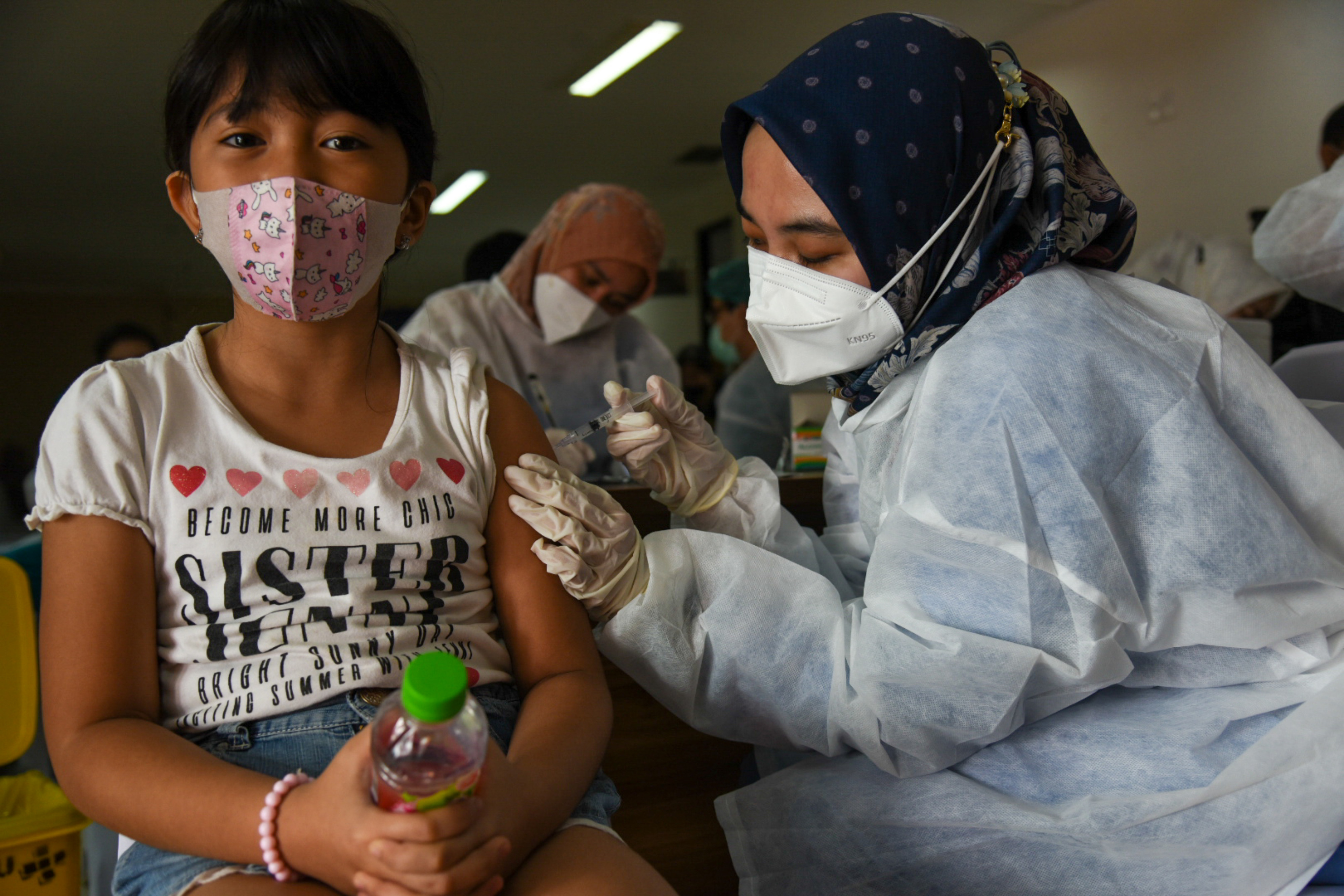 Petugas menyuntikkan vaksin covid-19 saat vaksinasi massal anak usia 6-11 tahun di RS USU, Kota Medan, Sumatera Utara, Kamis (30/12/2021). 