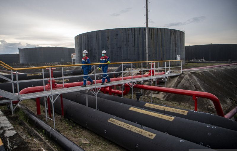 Pekerja PT Pertamina Hulu Rokan mengecek saluran pipa minyak yang menuju tangki pengumpul produksi minyak di Blok Rokan, Dumai, Riau. 