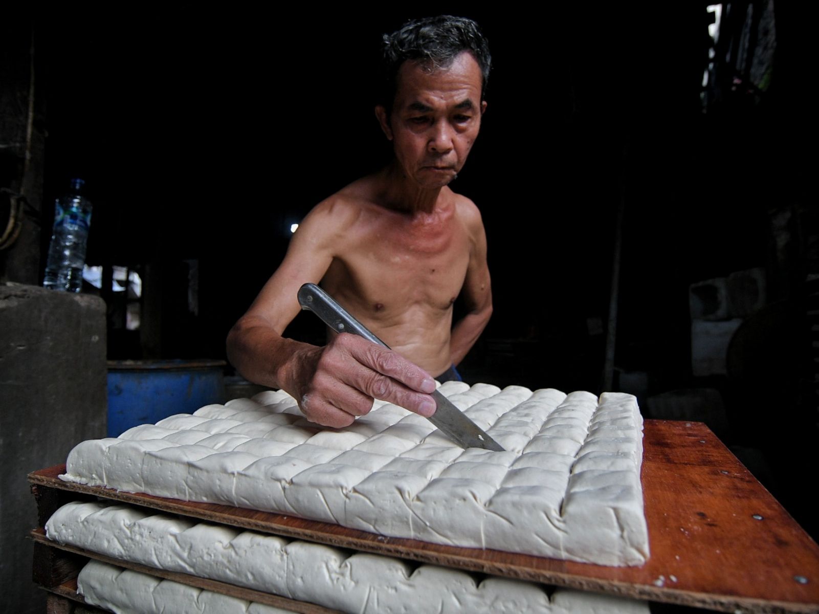 Pekerja menyelesaikan pembuatan tahu di pabrik kawasan Duren Tiga, Jakarta, Selasa (15/2/2022).