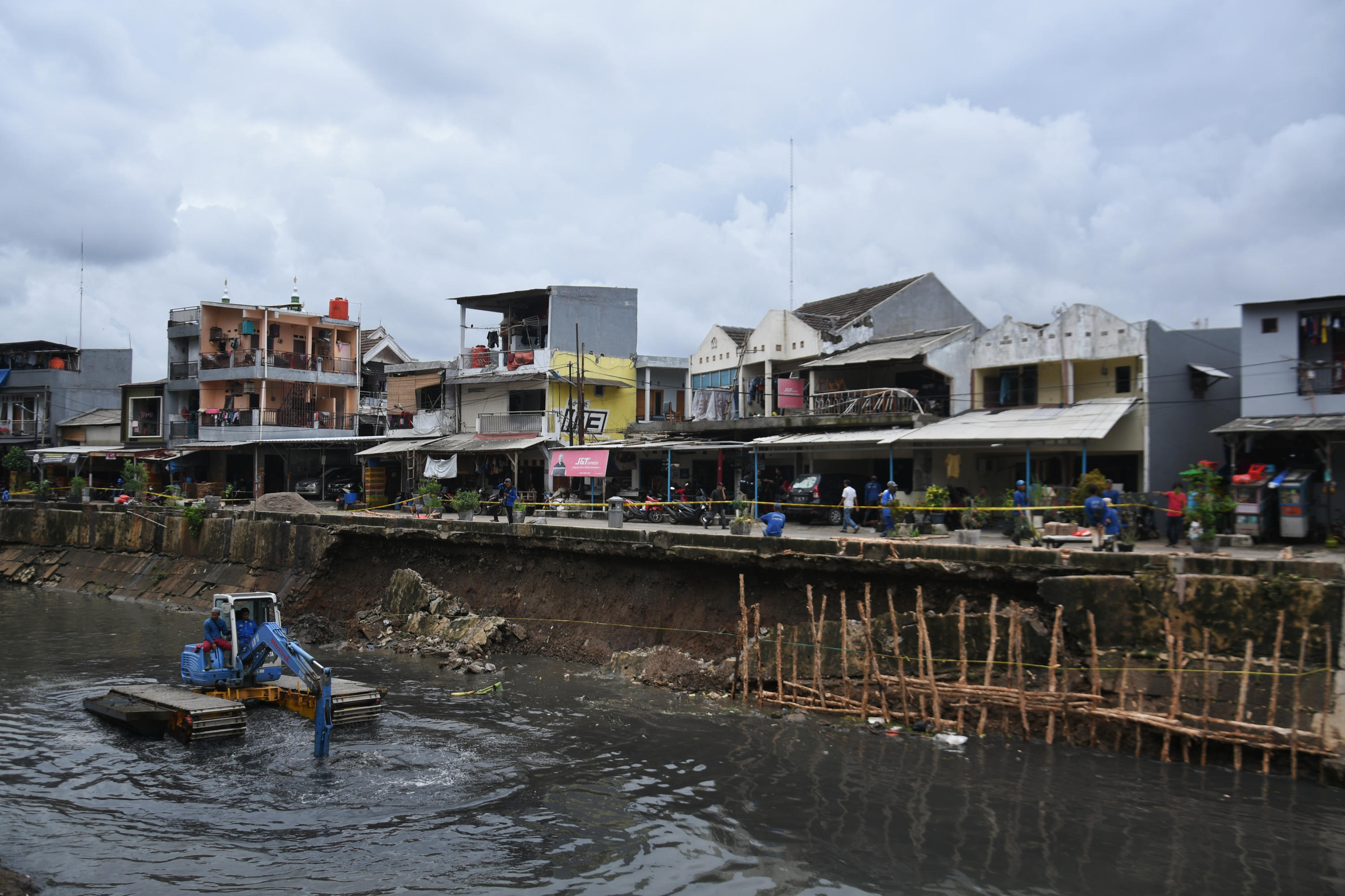 Petugas UPK Badan Air tengah memperbaiki turap Kali Sunter yang ambles di Jalan Cinta, Pulogadung, Jakarta Timur.