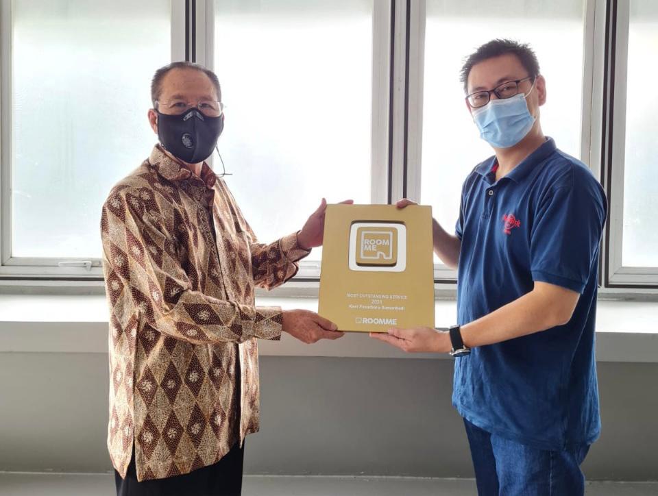 Rudianto Lim selaku General Manager RoomMe, memberi apresiasi kepada Haryanto Tanoyo, pemilik Kos Pasar Baru Samanhudi. 