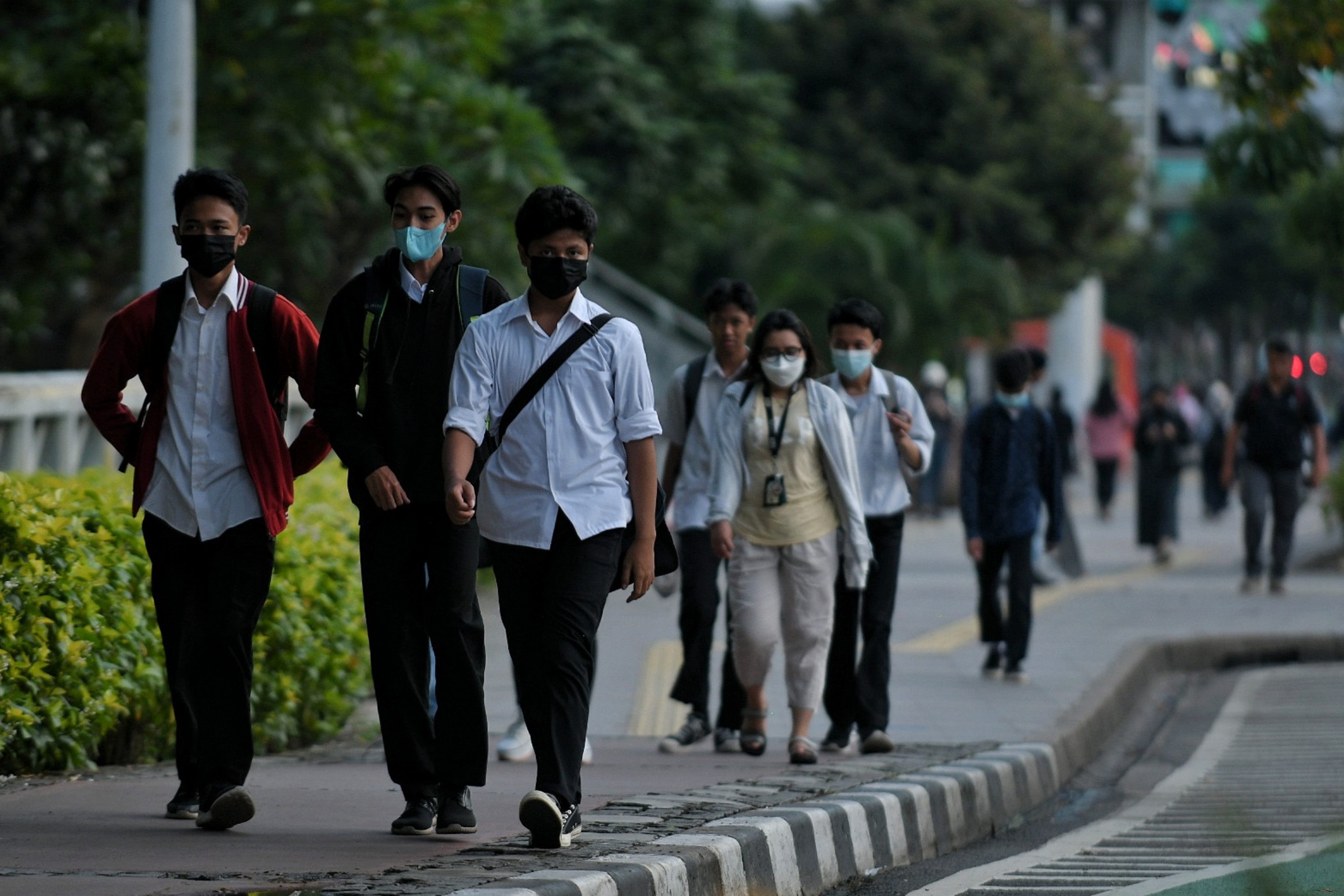 Pekerja melintas di Jalan Jenderal Sudirman pada jam pulang kerja