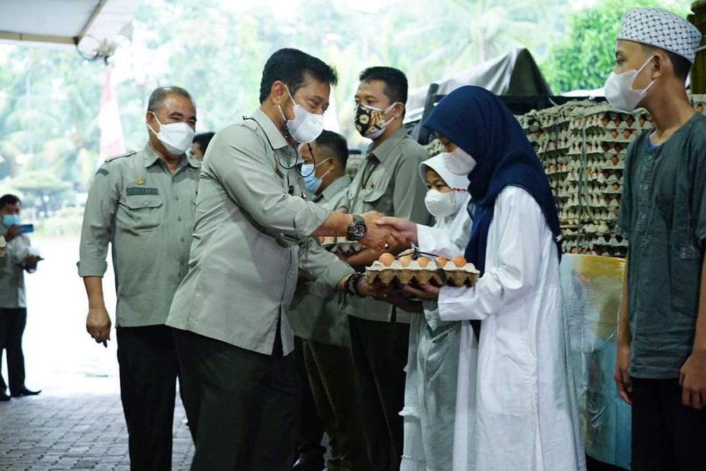 Menteri Pertanian Syahrul Yasin Limpo membagikan telur kepada warga. 