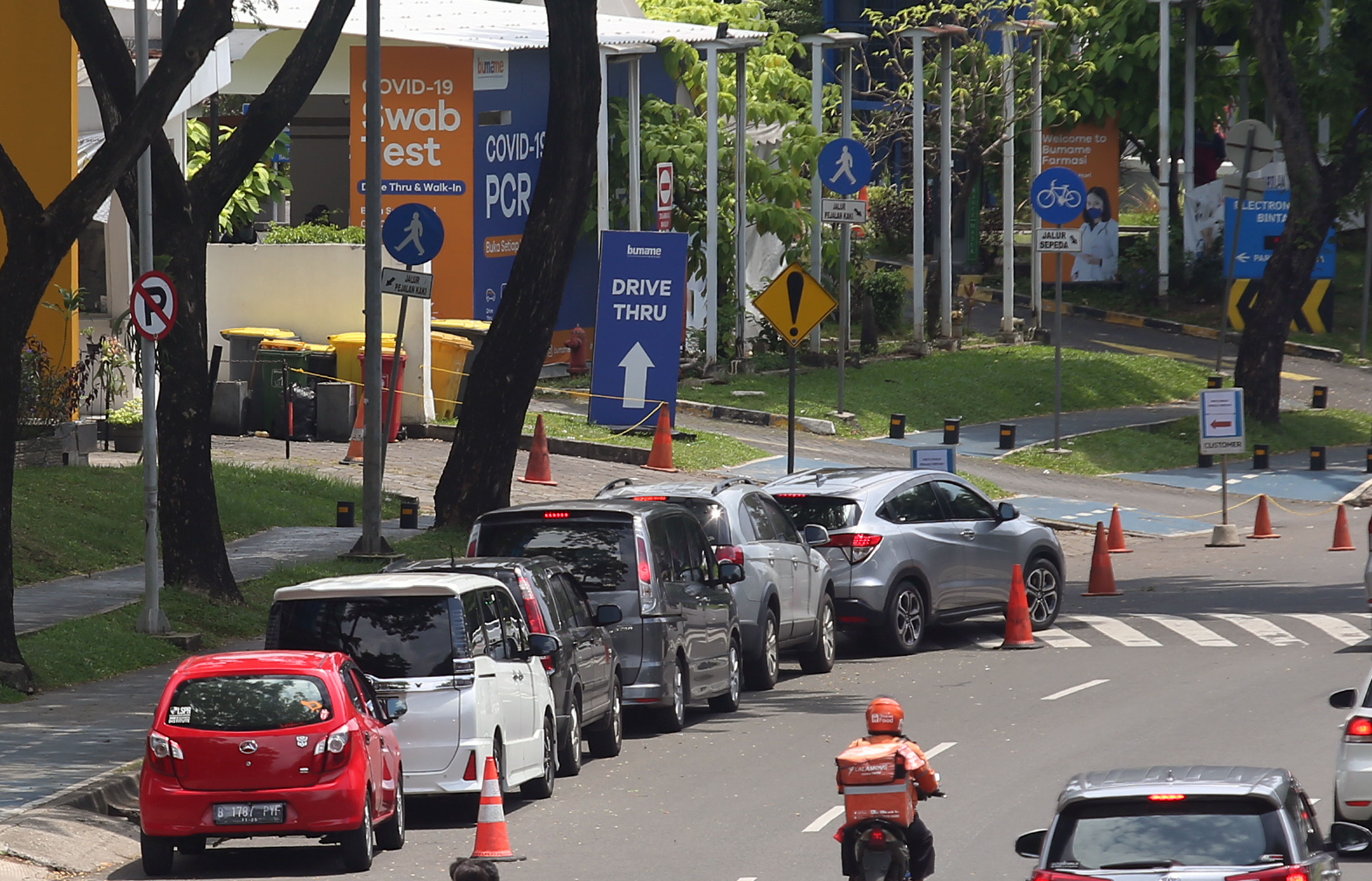 Pengendara mobil antre untuk melakukan tes usap PCR dan Antigen COVID-19 secara 