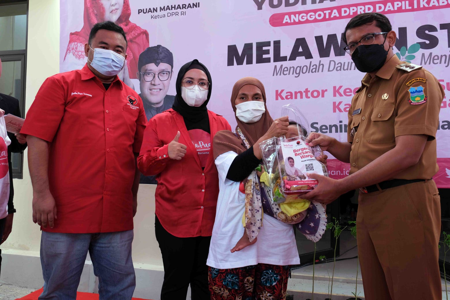 Wakil Bupati Garut dr. Helmi Budiman (kanan) memberi paket kepada ibu yang peserta Gerakan Melawan Stunting di Kecamatan Sukawening, Garut.