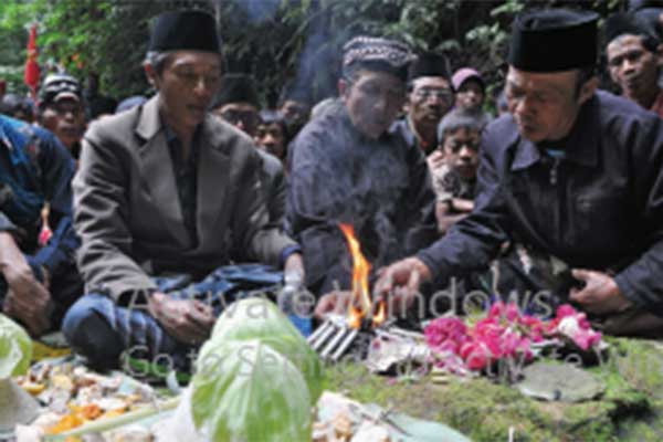 Sesepuh desa memimpin doa di depan mata air Tlompak.