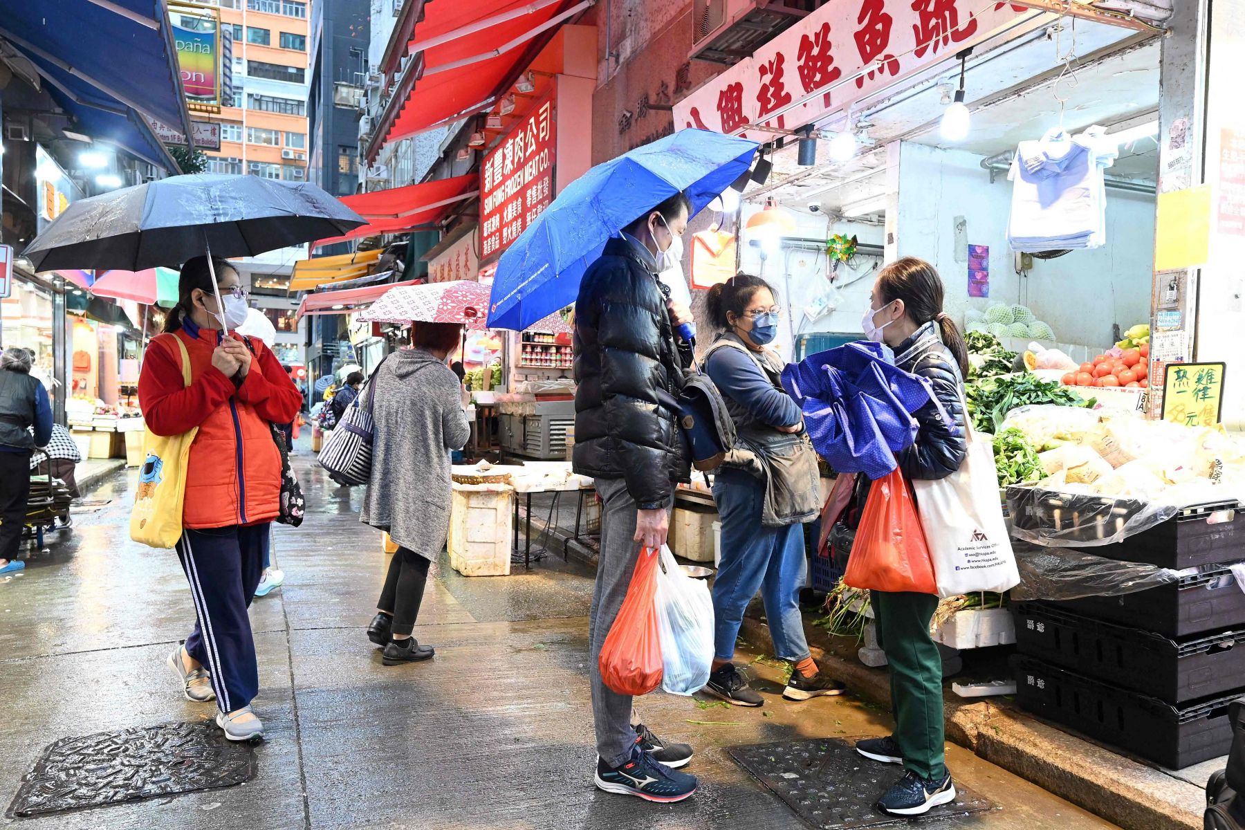 Warga mengenakan masker saat berbelanja di toko kebutuhan pokok di sebuah pasar di Hong Kong, Kamis (17/2). 
