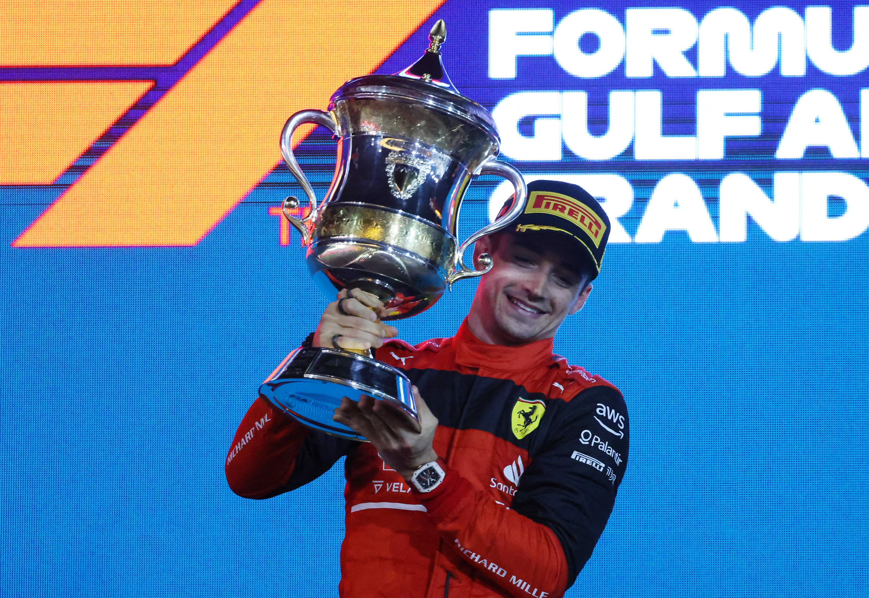 Pembalap Ferrari Charles Leclerc mengangkat trofi juara di GP Bahrain.